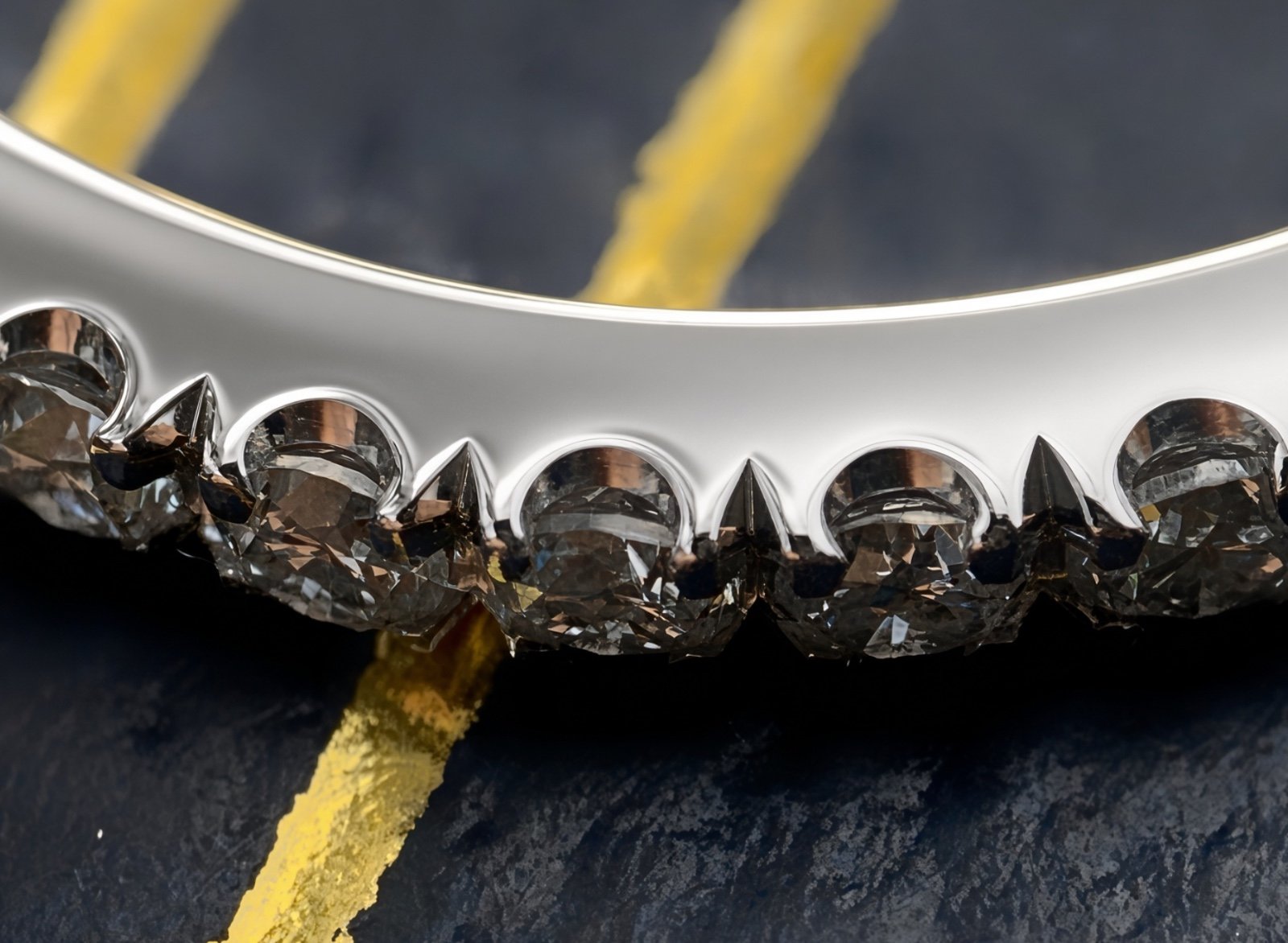 Pavé diamond band on a white-gold engagement ring, side view