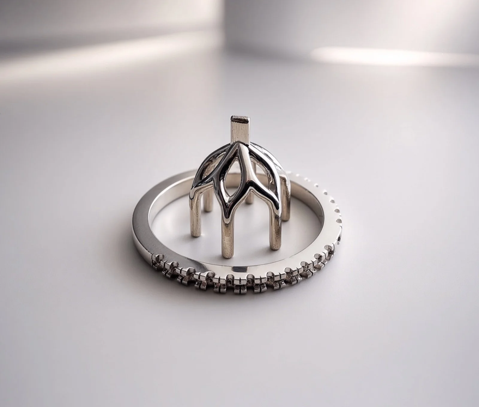White-gold petal setting with a pavé band, before the centre stone is set