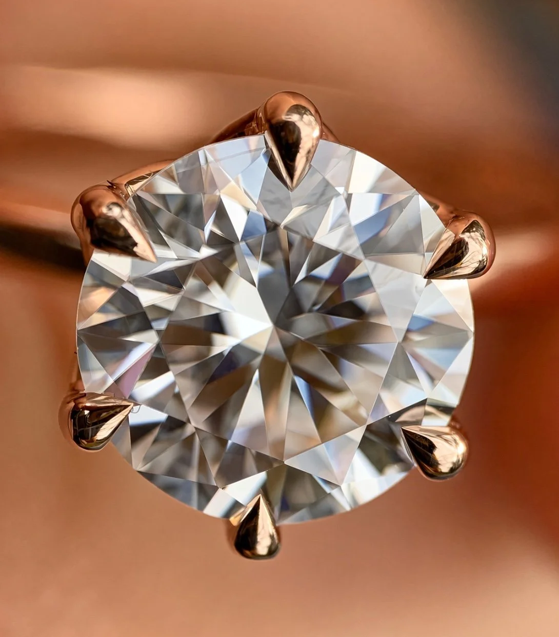 14k rose gold six prong petal floral head tiger claw prongs hand set engagement ring close up top view.