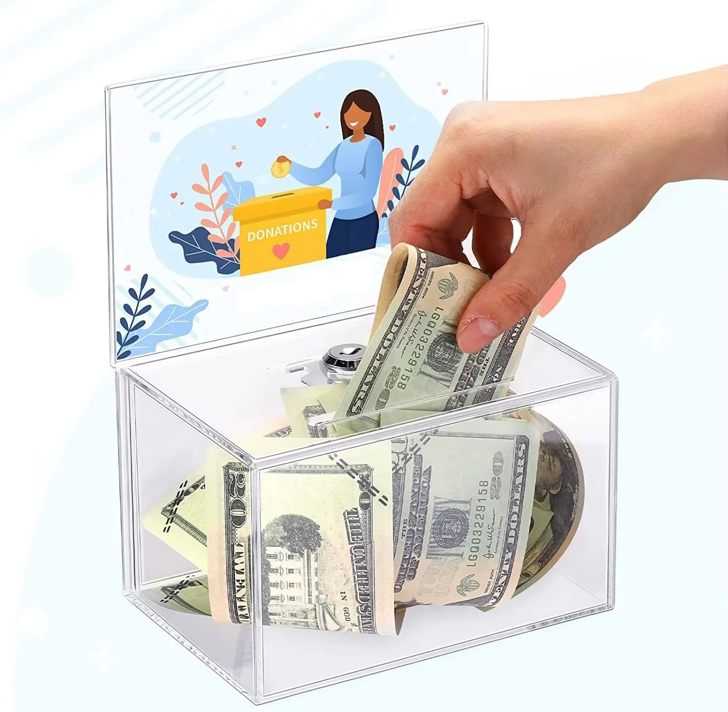 A hand placing folded U.S. dollar bills into a transparent donation box with a colorful illustration of a woman dropping coins into a donation box on its lid.