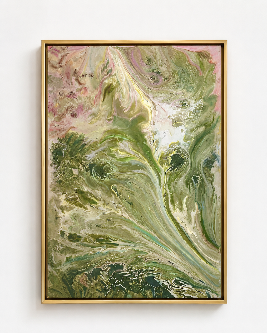 Abstract swirling green, pink, and white paint design framed in gold, hanging on a white wall.
