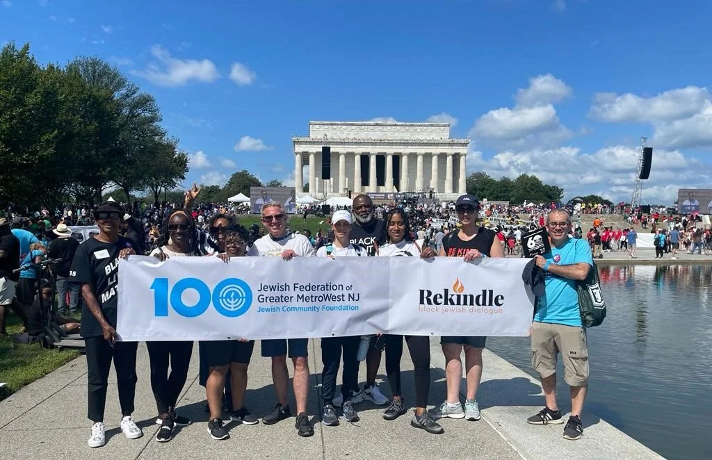 A group of people holding a banner in front of the Lincoln Memorial at the National Mall in Washington, D.C.