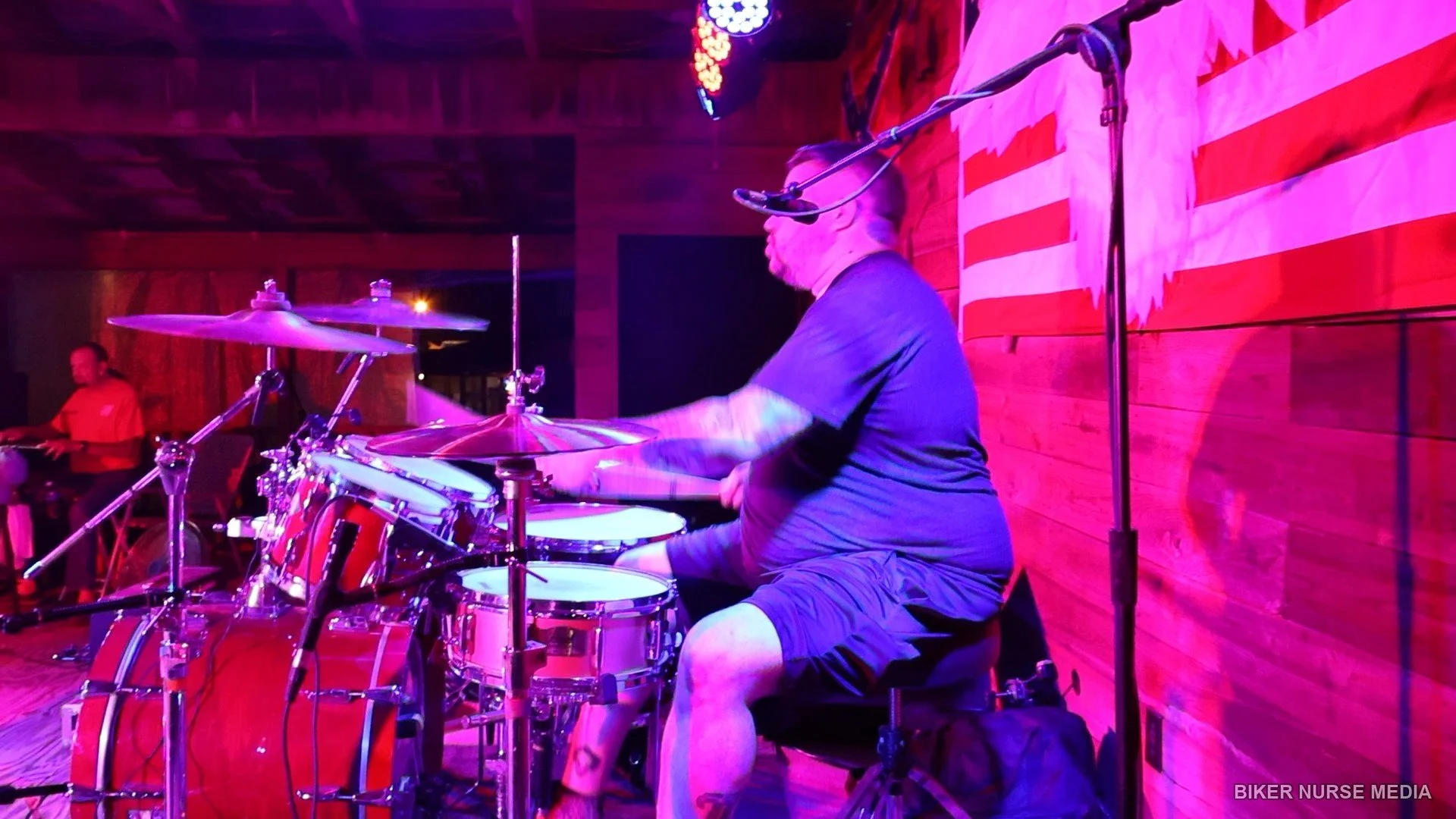 Drummer performing live at a motorcycle rally photographed by Biker Nurse Media