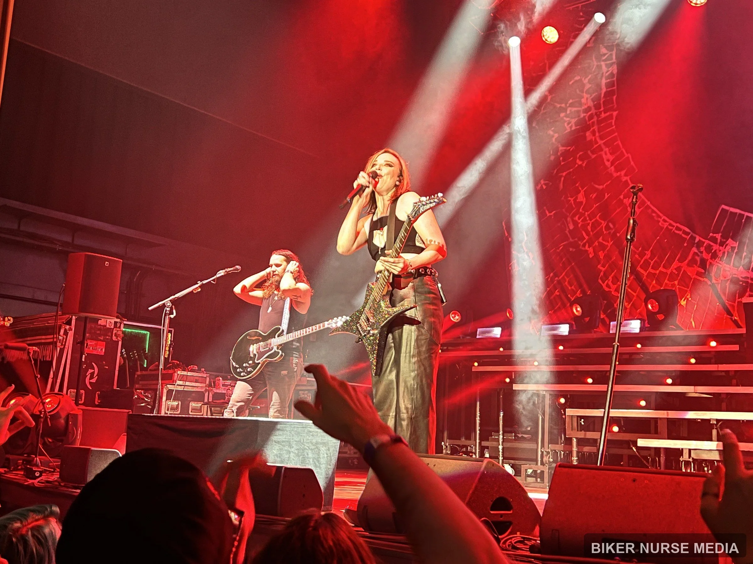 Halestorm performing live under red stage lights, photographed by Biker Nurse Media