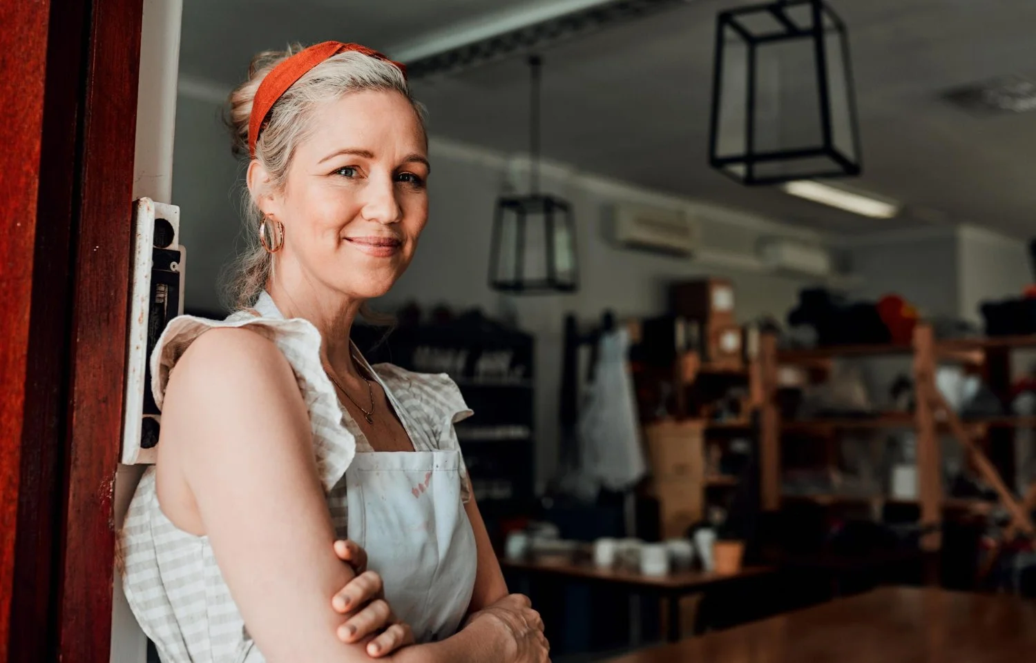 Confident female business owner smiling, representing the ambitious entrepreneurs and small businesses Bonehead Design helps through branding and website design.
