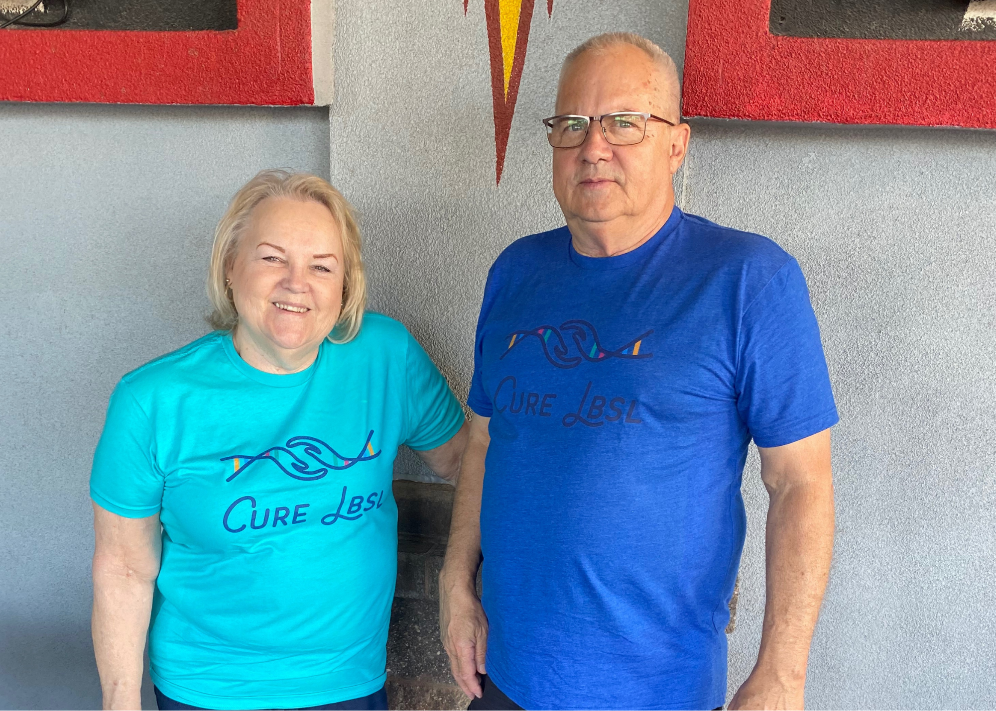 Older couple wearing Cure LBSL t-shirts