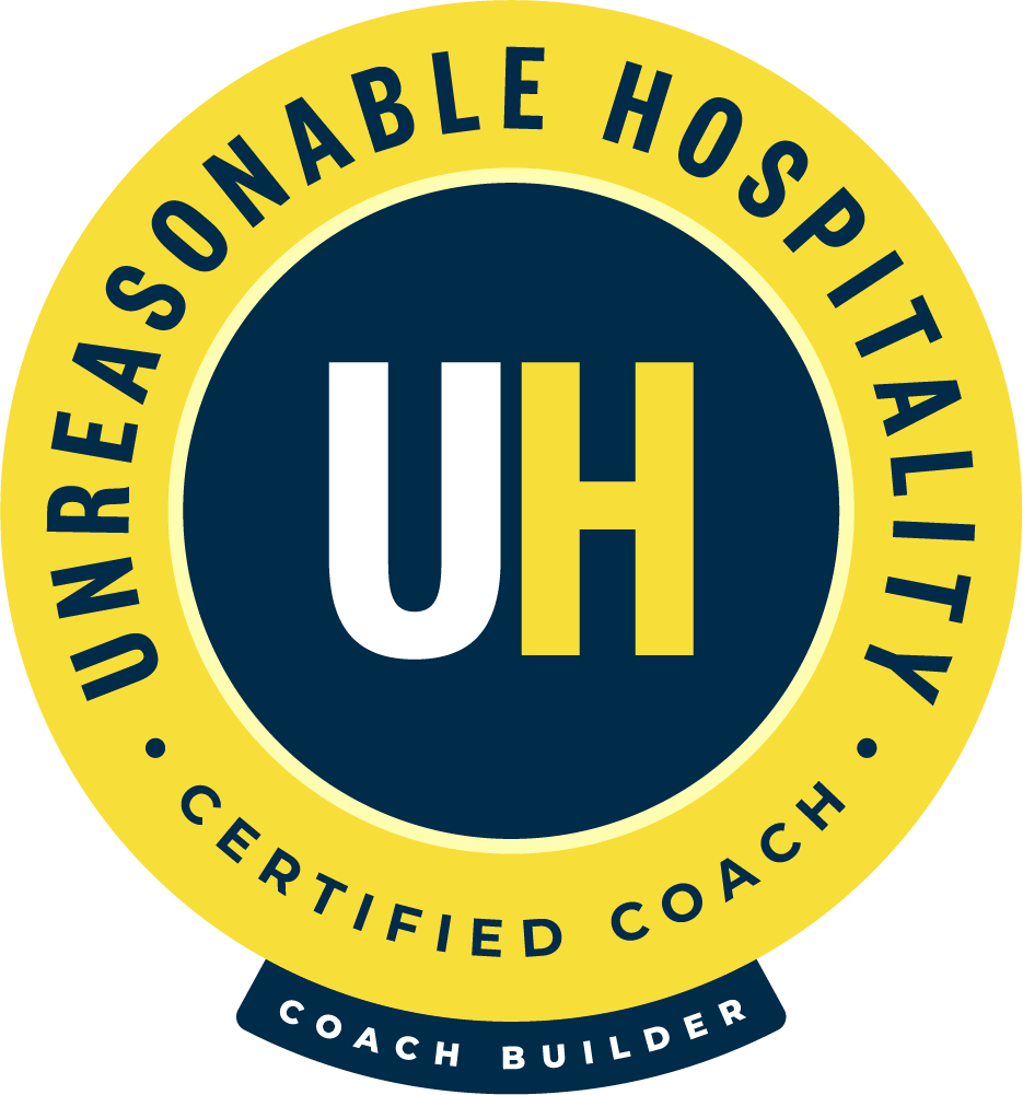 Logo for a certified coach trainer with a yellow circular border, the words 'UReaSOnable HOSpItaLity' around the top, 'CERTIFIED COACH' at the bottom, and 'COACH BUILDER' on a dark blue banner at the very bottom, with a dark blue inner circle containing the white and yellow letters 'UH' in the center.