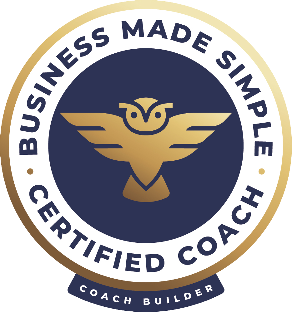 A circular badge with gold, navy, and white colors that reads 'Business Made Simple, Certified Coach, Coach Builder'. The badge features a stylized gold owl with outstretched wings in the center.
