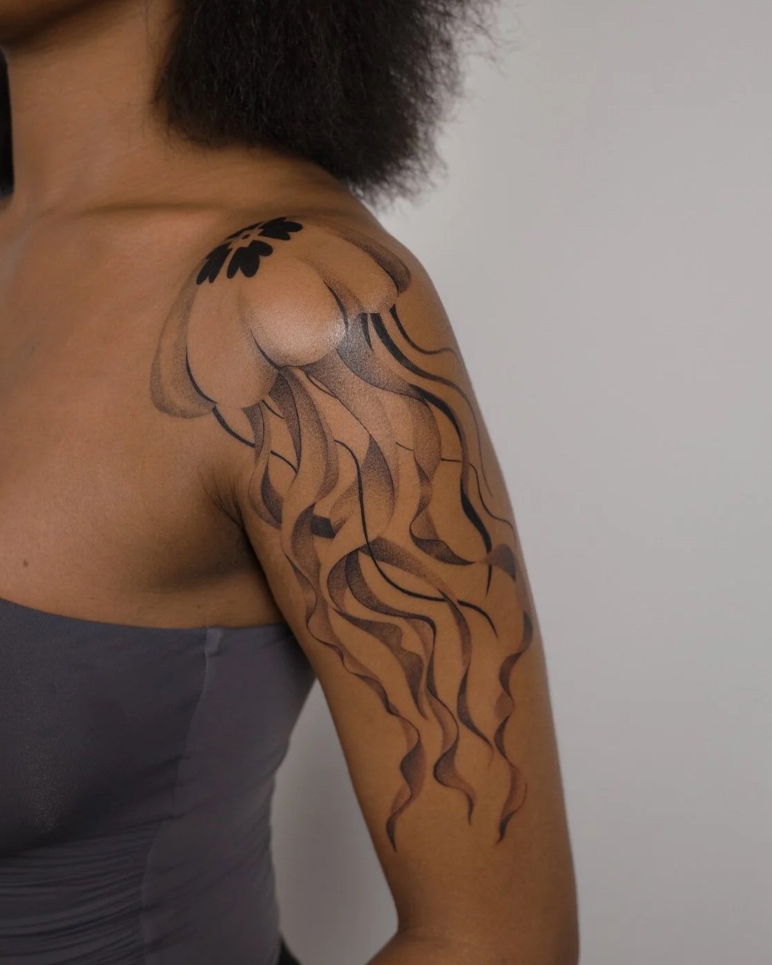 Shoulder and upper arm tattoo of a jellyfish with ornamental design and flowing lines by New York based contemporary tattoo artist, Ginseng Ink.