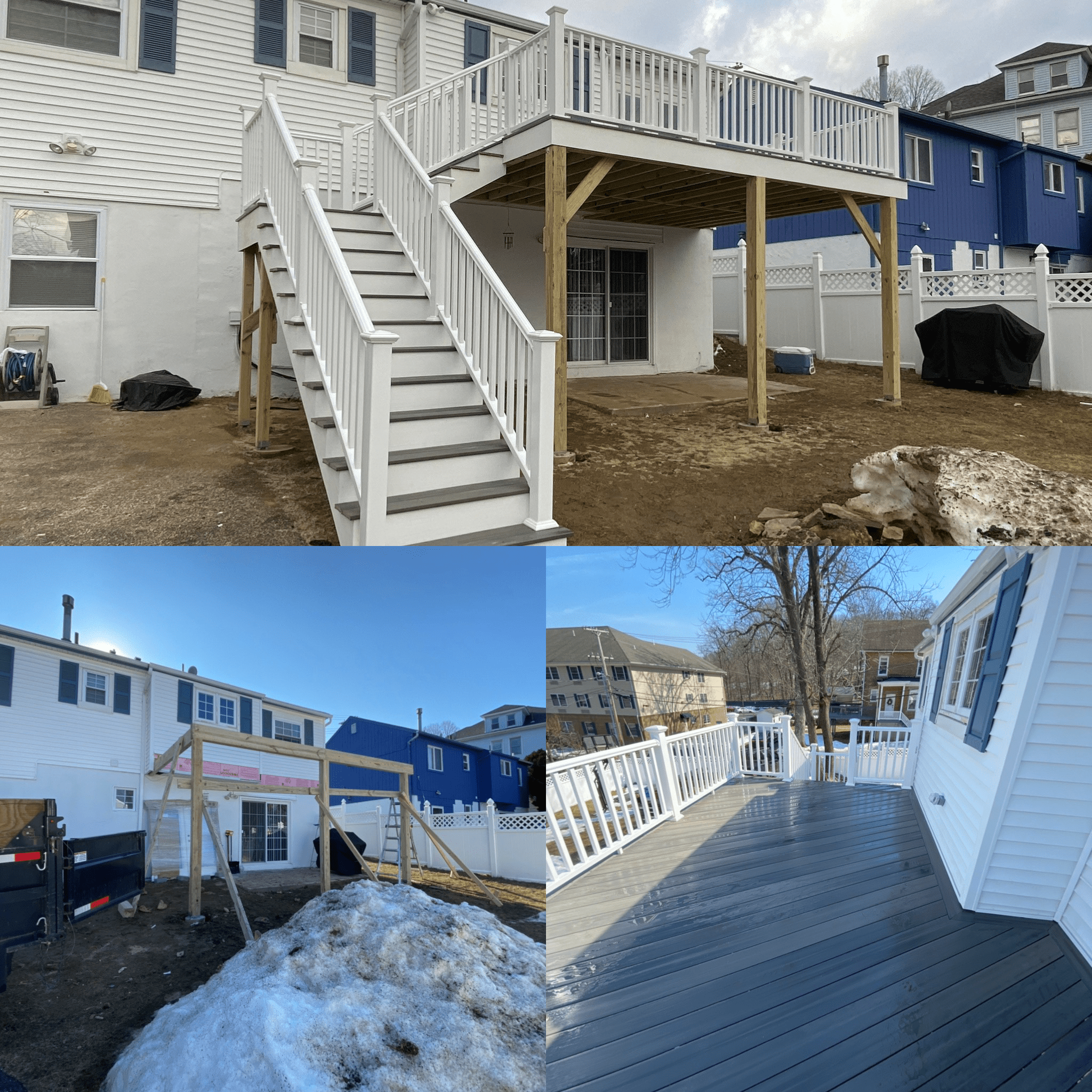 Backyard with newly built elevated deck with white railing, stairs, and support beams, with neighboring houses visible and patches of snow on the ground.