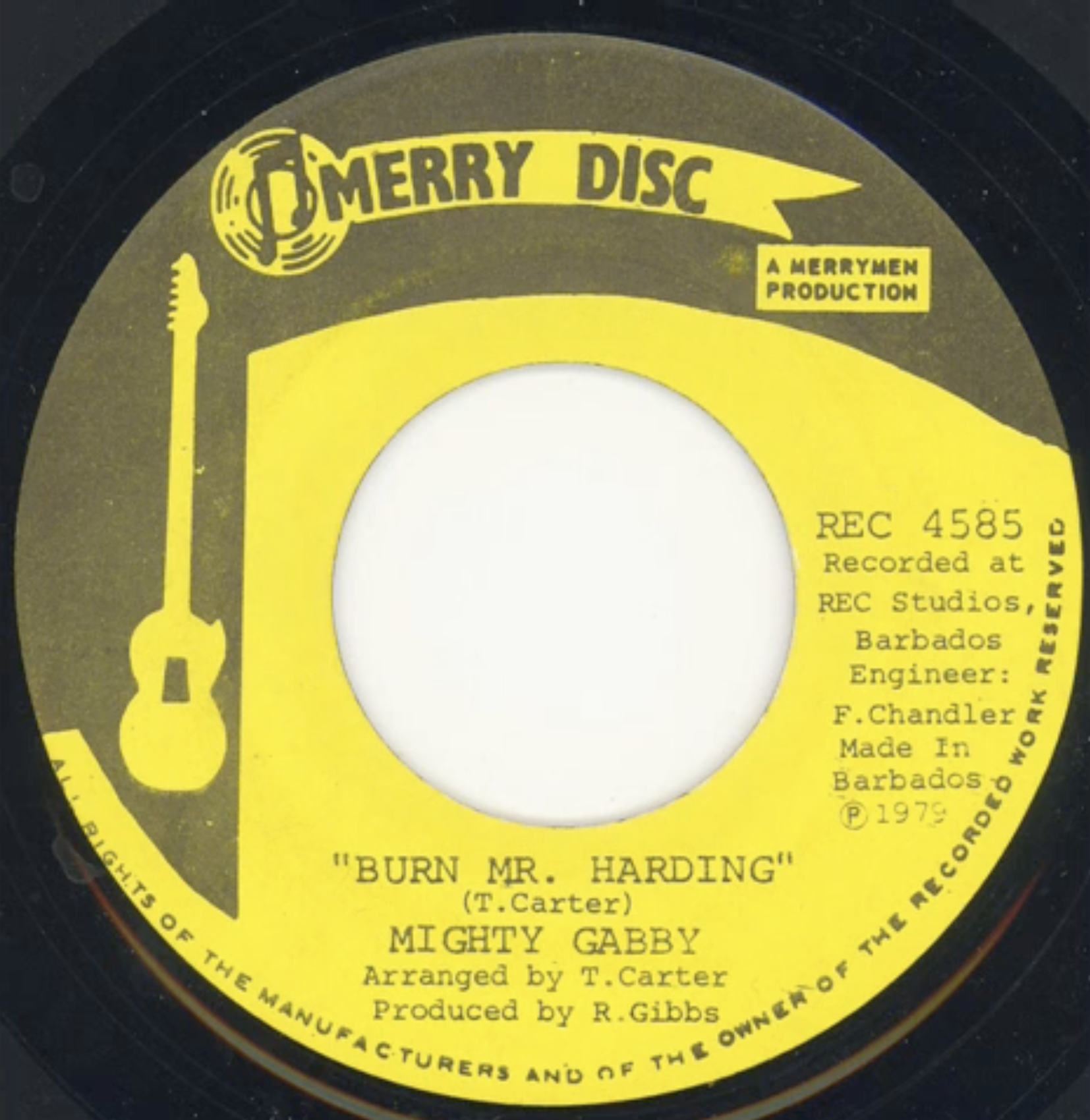 Close-up of a 45 RPM vinyl record label titled 'Merry Disc' with yellow and black design. Song title 'Burn Mr. Harding' by Mighy Gabby, arranged by T. Carter, produced by R. Gibbs, recorded in Barbados 1979.
