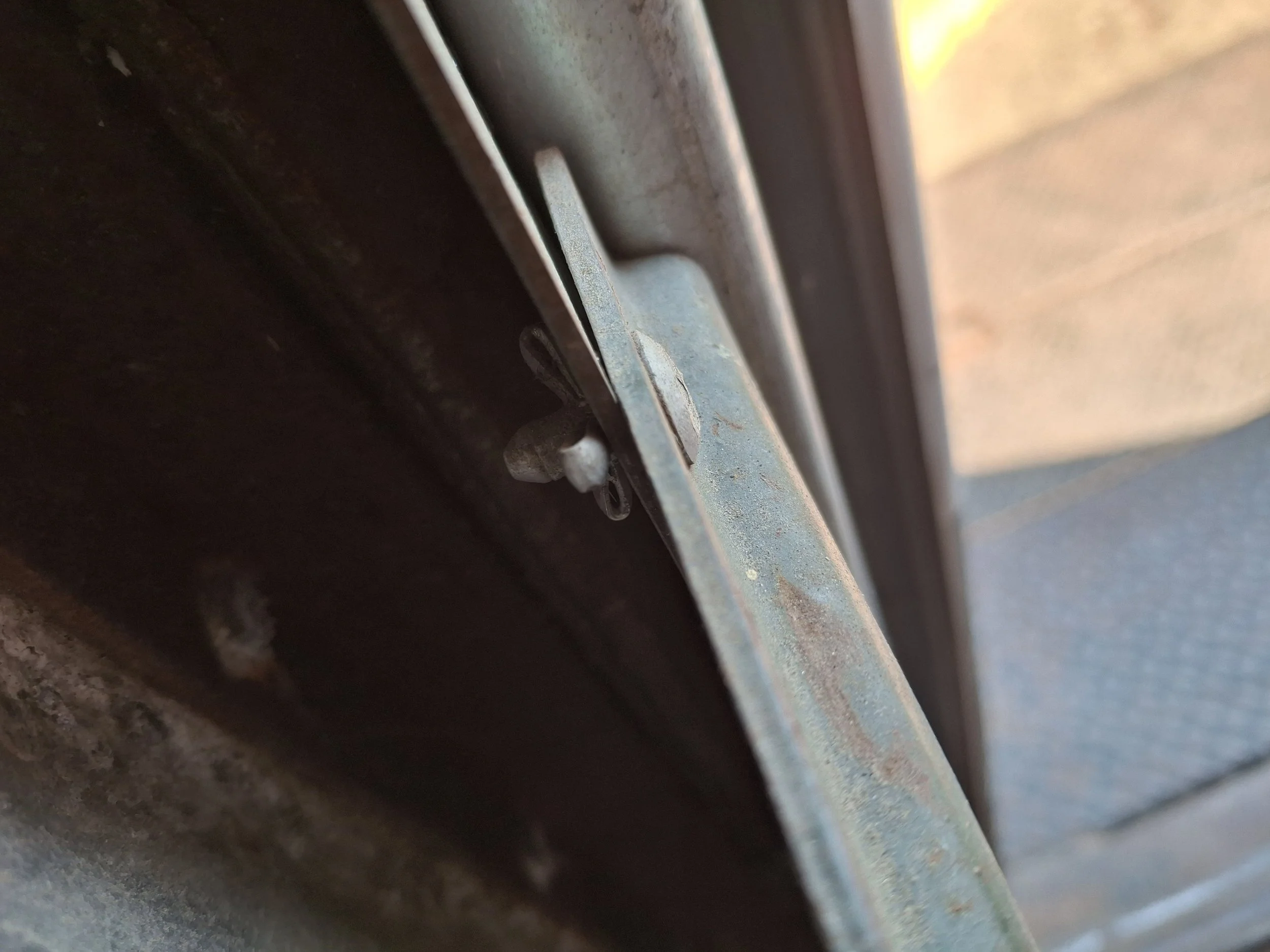 Close-up of the commercial cargo box door and hardware on a 20-foot Isuzu NPR before its transformation into a DIY off-grid RV and mobile storytelling studio for The Two Miracles Project.