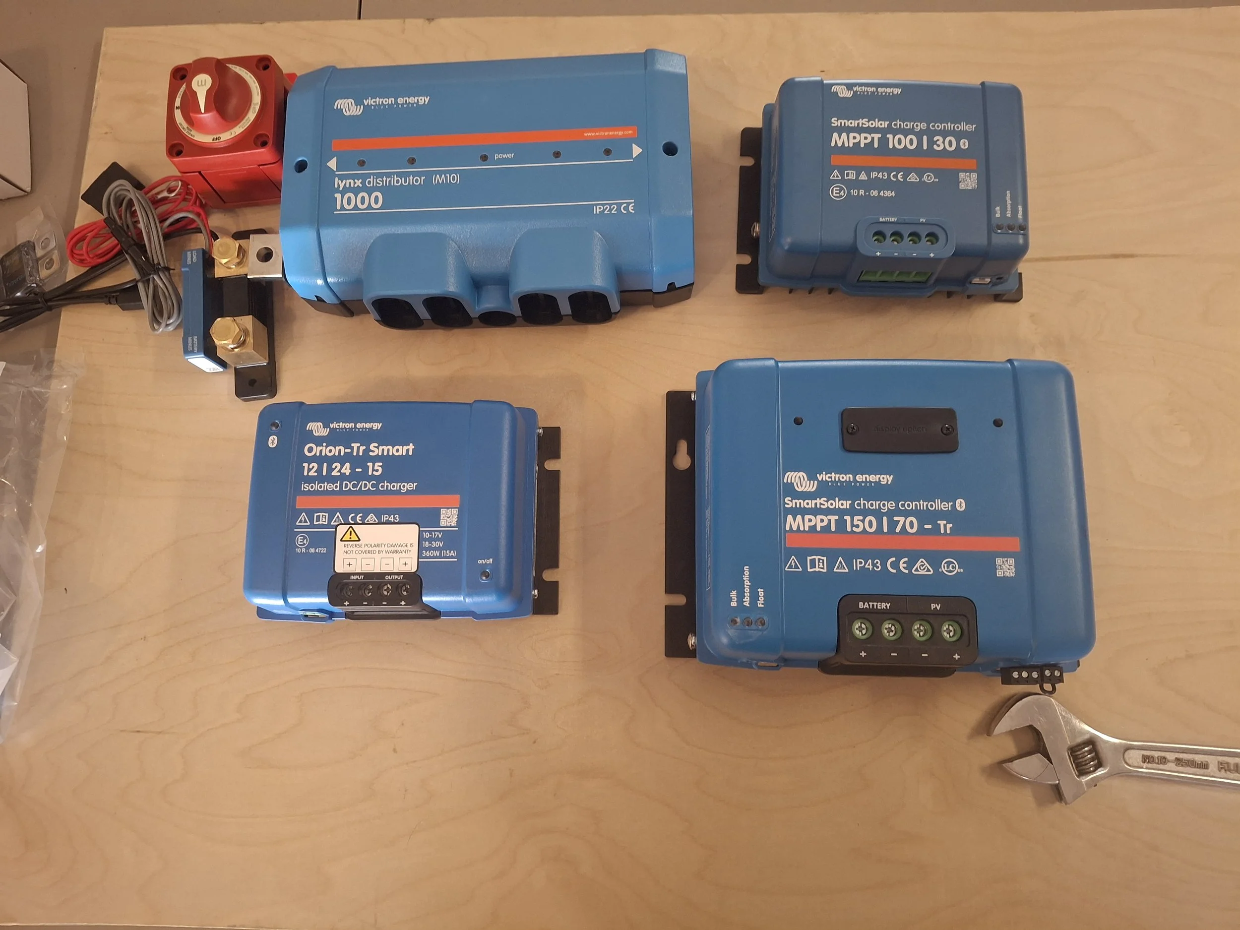 Victron Energy solar and electrical components for a 24-volt off-grid power system, including MPPT solar charge controllers, battery monitoring, DC-DC charging, and inverter equipment for a DIY truck camper conversion.
