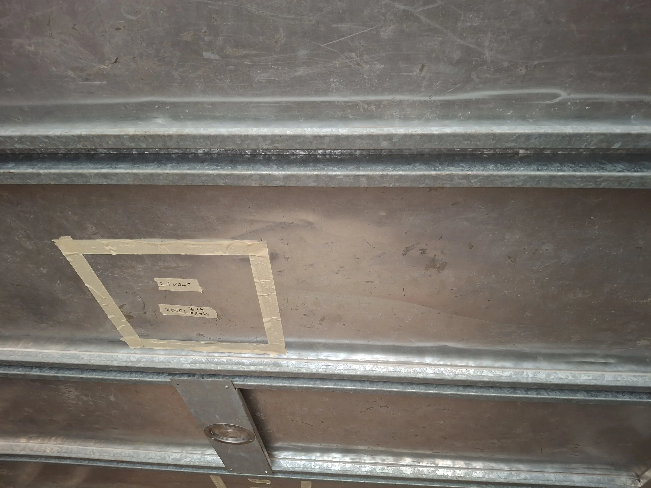 24-volt electrical system marking inside the Isuzu NPR truck during construction of an off-grid power system using Victron Energy components for a DIY mobile storytelling studio and RV conversion.