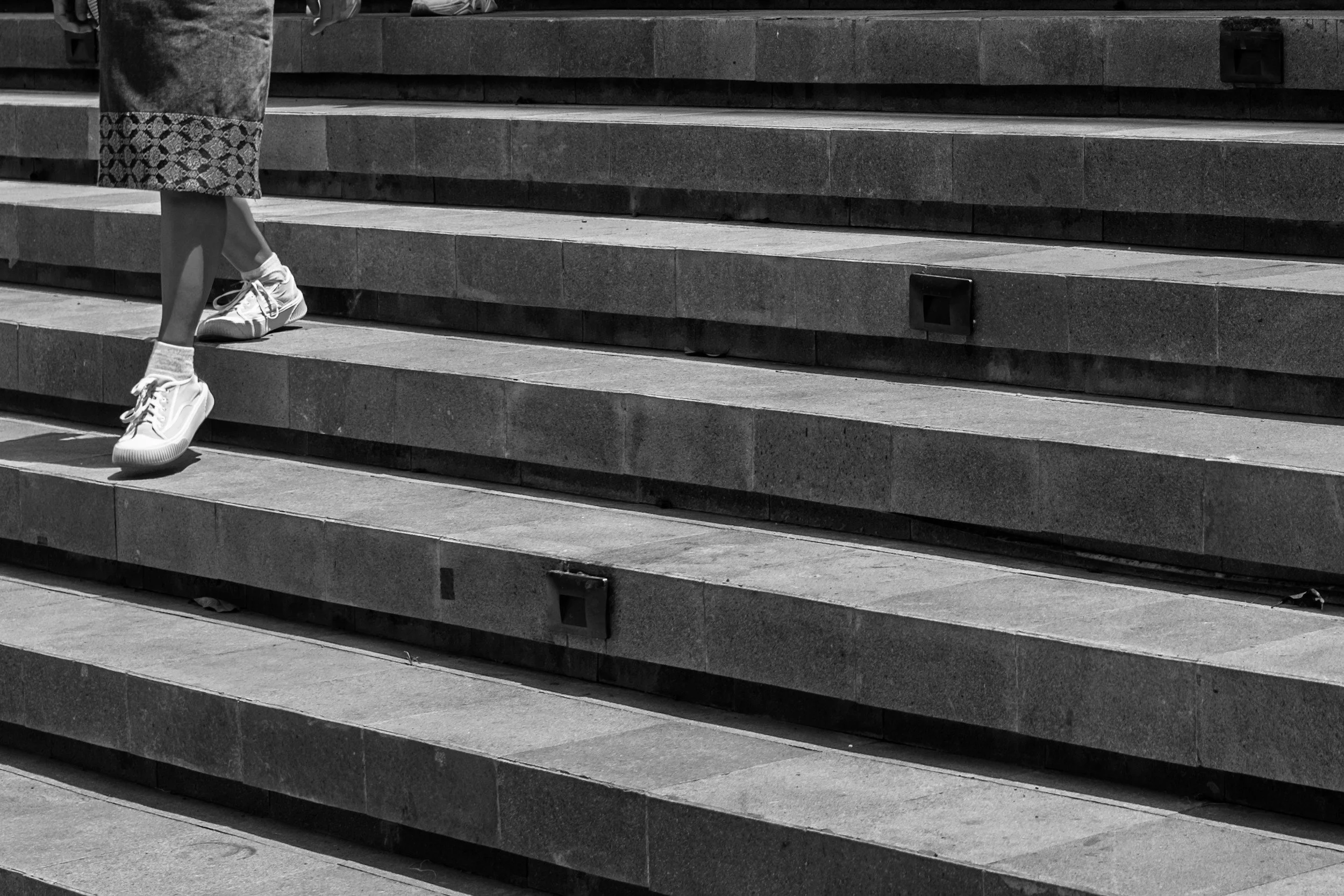 Person walking up stairs, representing personal growth, progress, and intentional change.