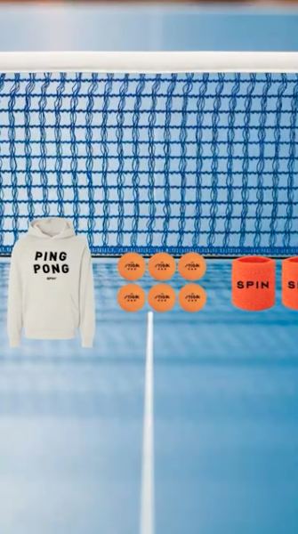 Spin Ping Pong branded hoodie laid out beside orange ping pong balls and a net on a blue table, merch graphic for a Toronto social club