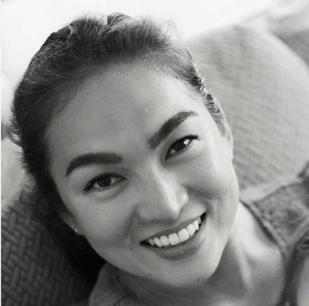 Stephanie Weden, mother, teacher, and founder of WedenMG, sitting down and looking up at the camera smiling.
