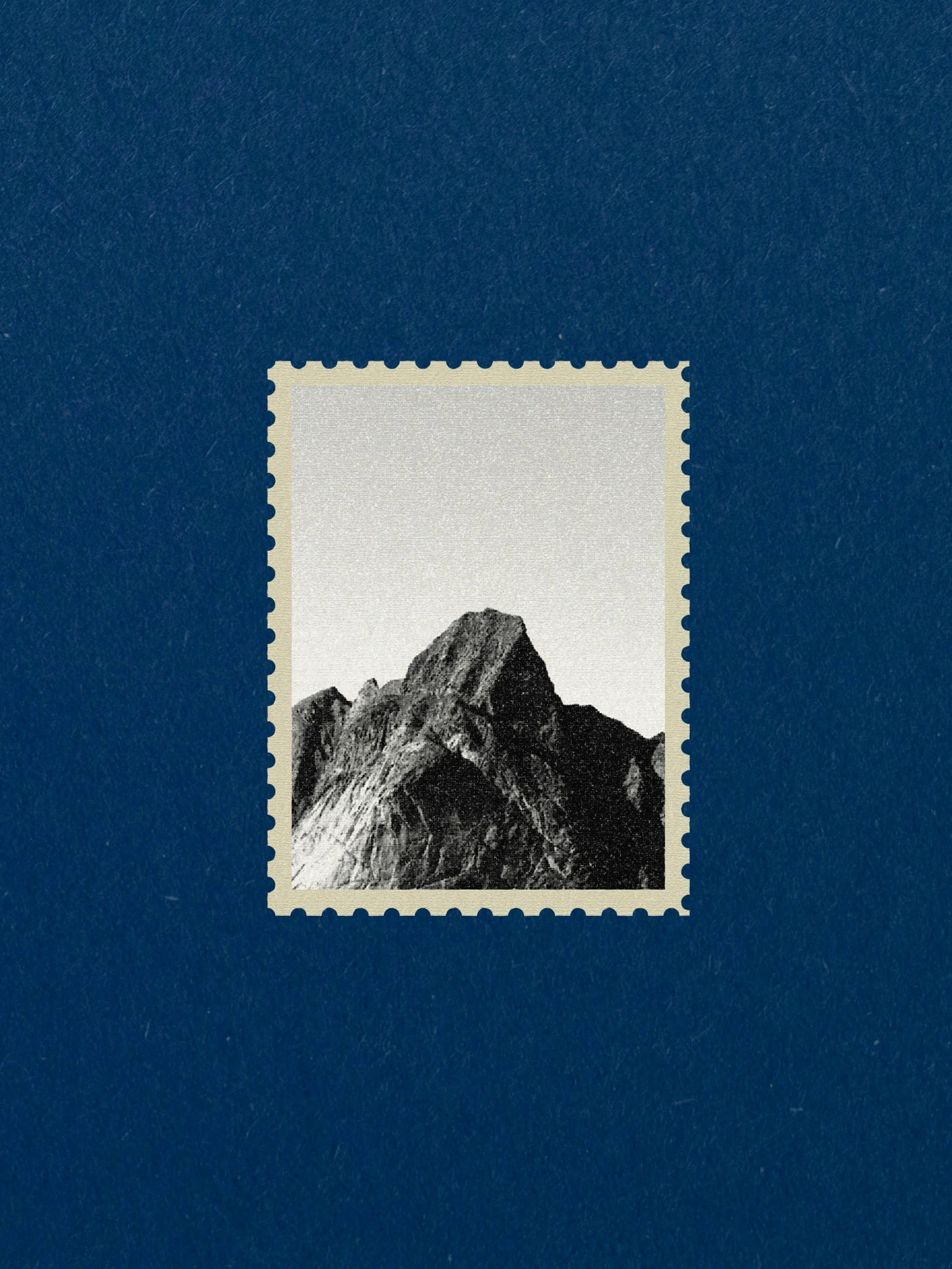 A postage stamp featuring a black-and-white photograph of a mountain peak against a plain sky.
