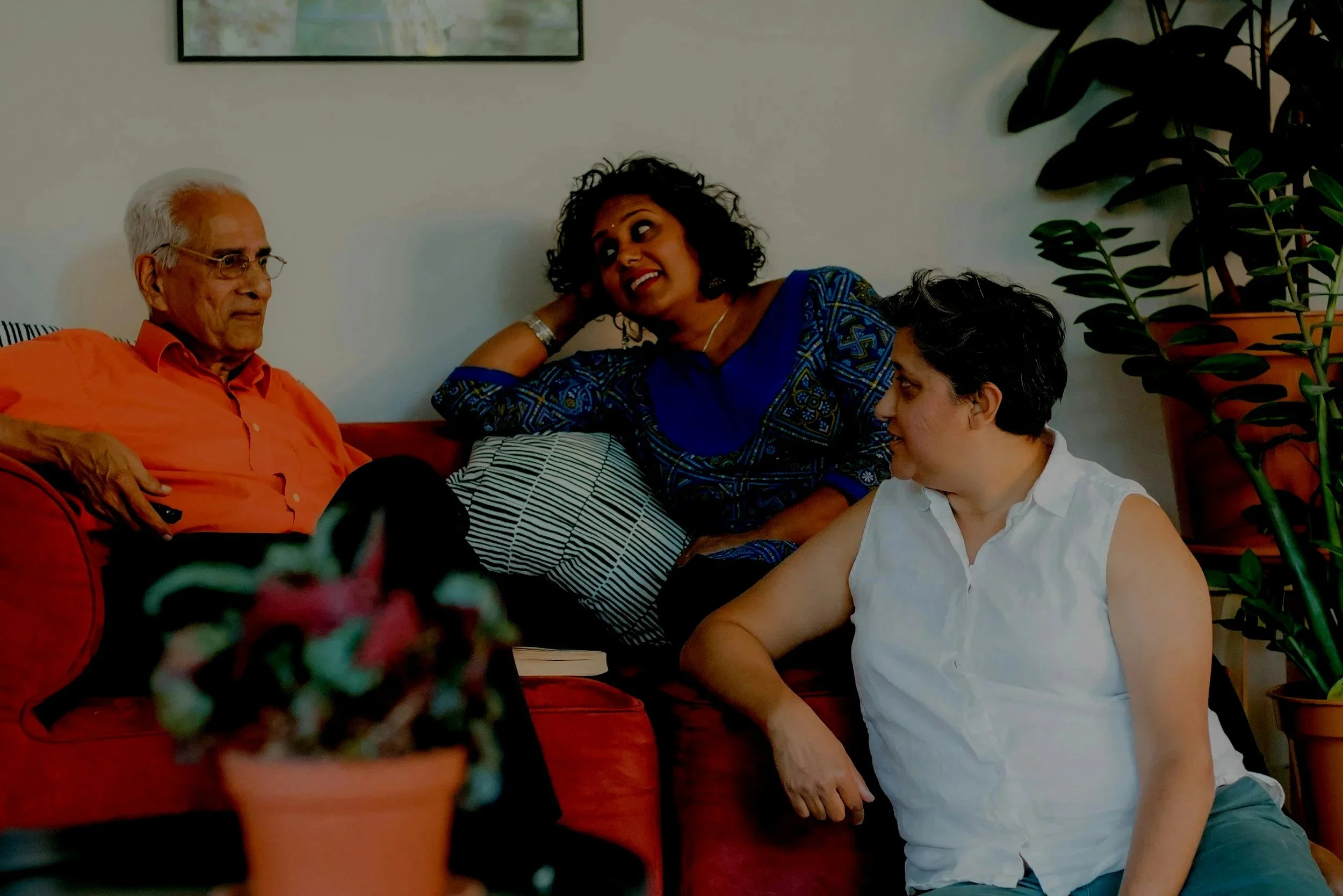 Three individuals sitting on a couch