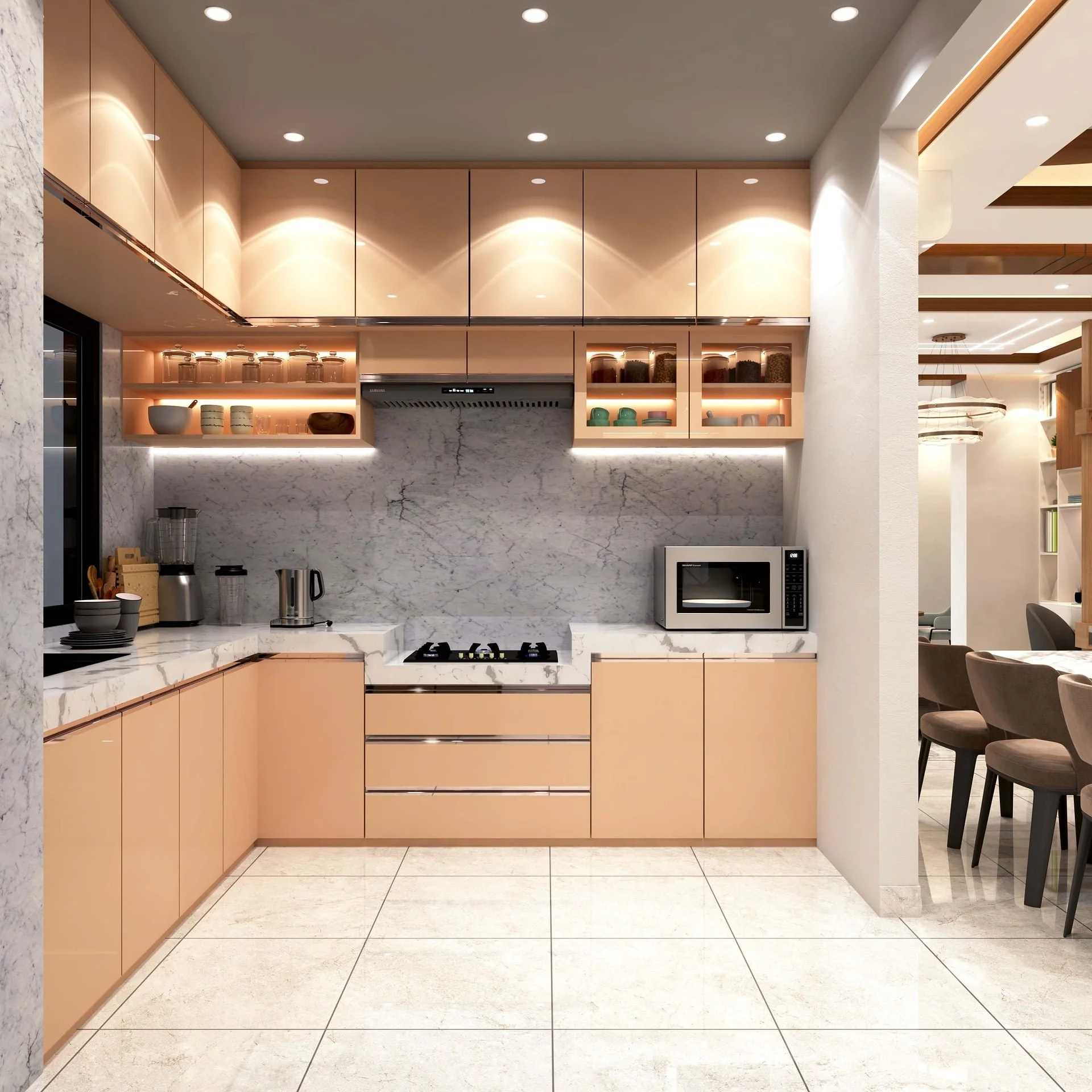 Modern kitchen with beige cabinets, white marble countertops, and built-in appliances, including microwave and stove, with a view into a dining area with chairs.