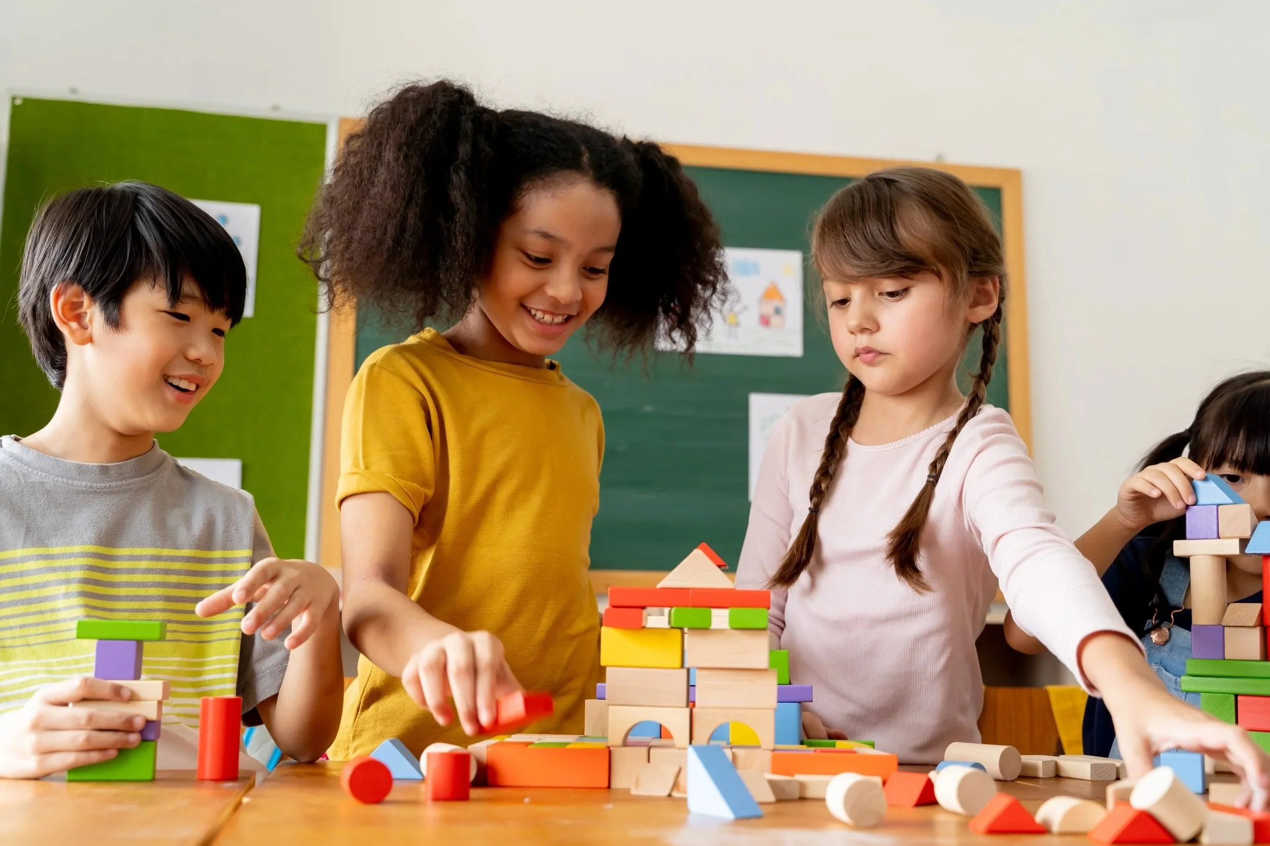 Children playing at a table with colorful toys during adapted, sensory play at an indoor play gym in Orange County, CA