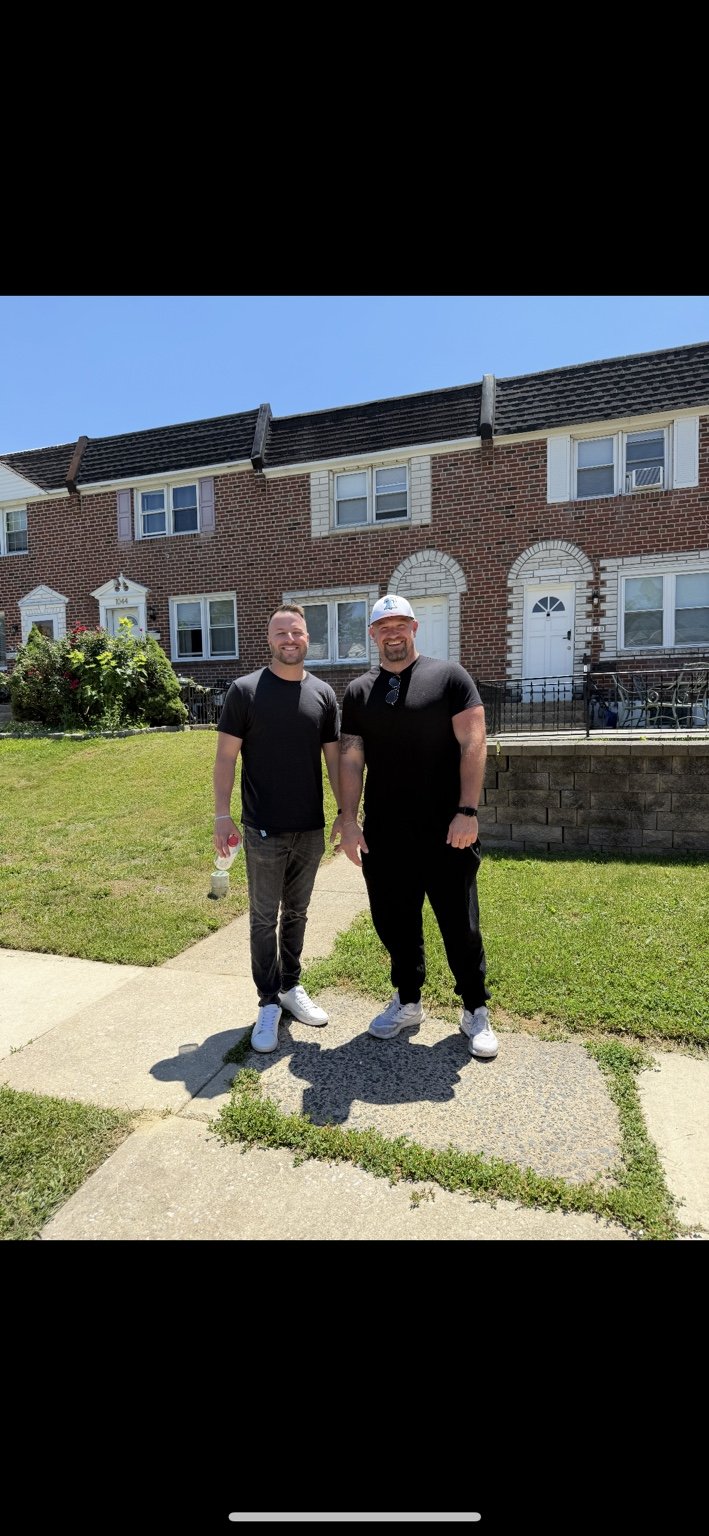Kevin and Bobby of DeLaw Acquisitions in front of local rowhomes in Delaware County, Pennsylvania.