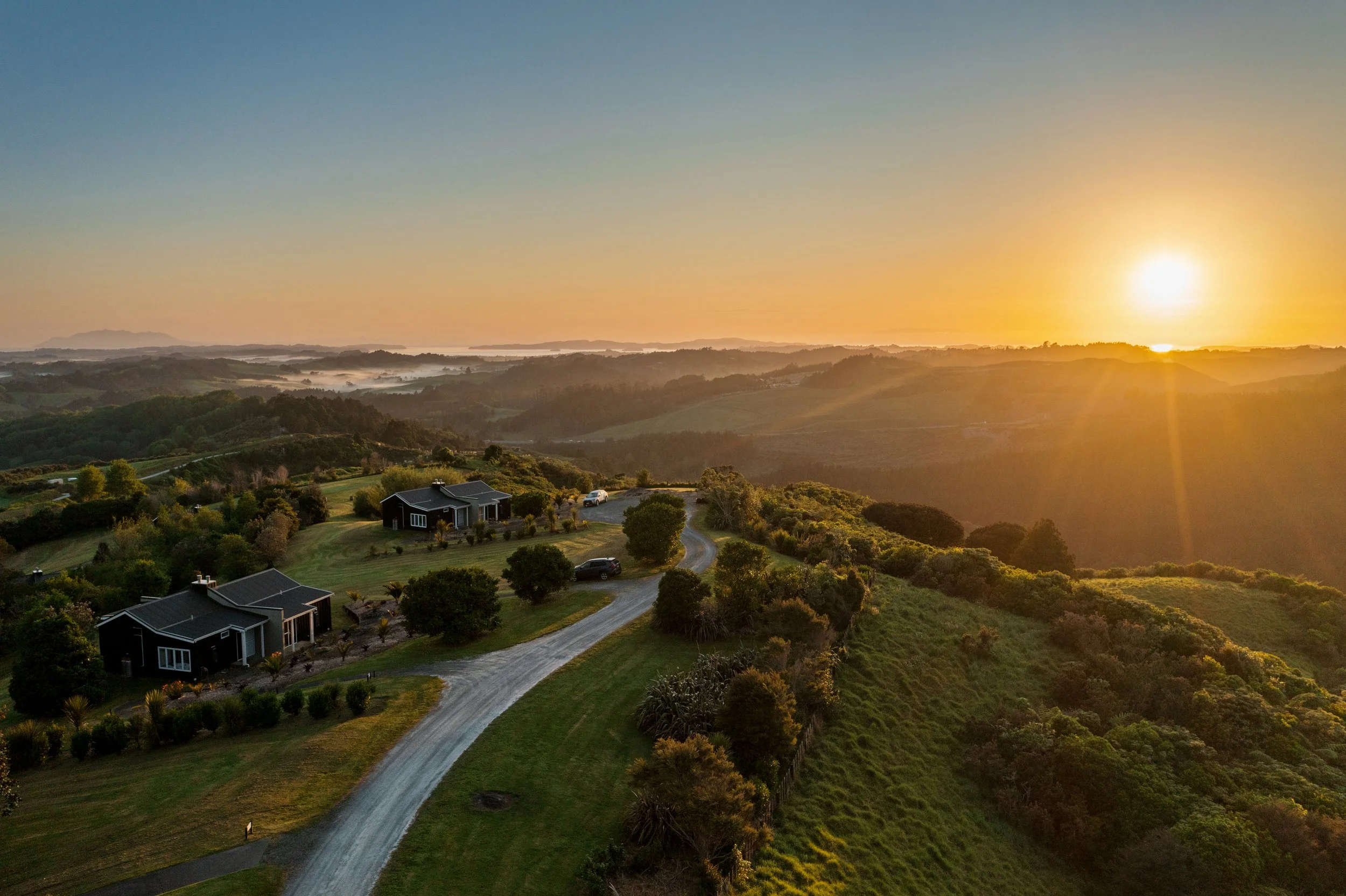 Sunset over Woodhouse Mountain Lodge and the surrounding Matakana countryside.