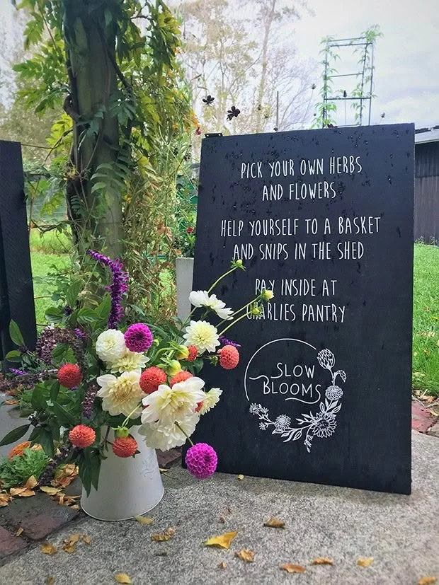 Pick-your-own flowers and herbs sign at a local garden on the Matakana Coast near Warkworth, New Zealand.