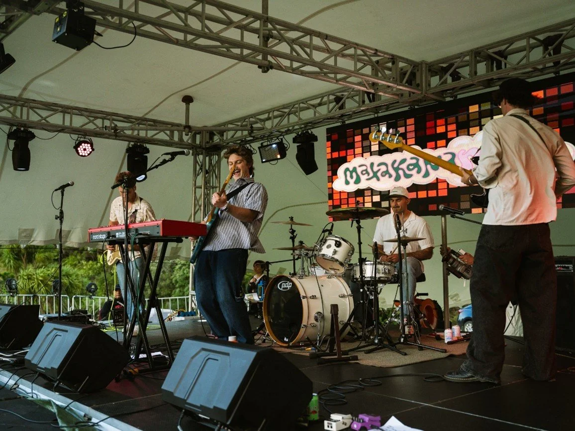 Live band performing on stage at a Matakana Coast music festival near Warkworth, New Zealand.