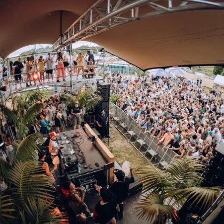 Crowd gathered at an outdoor music festival on the Matakana Coast near Warkworth, New Zealand.