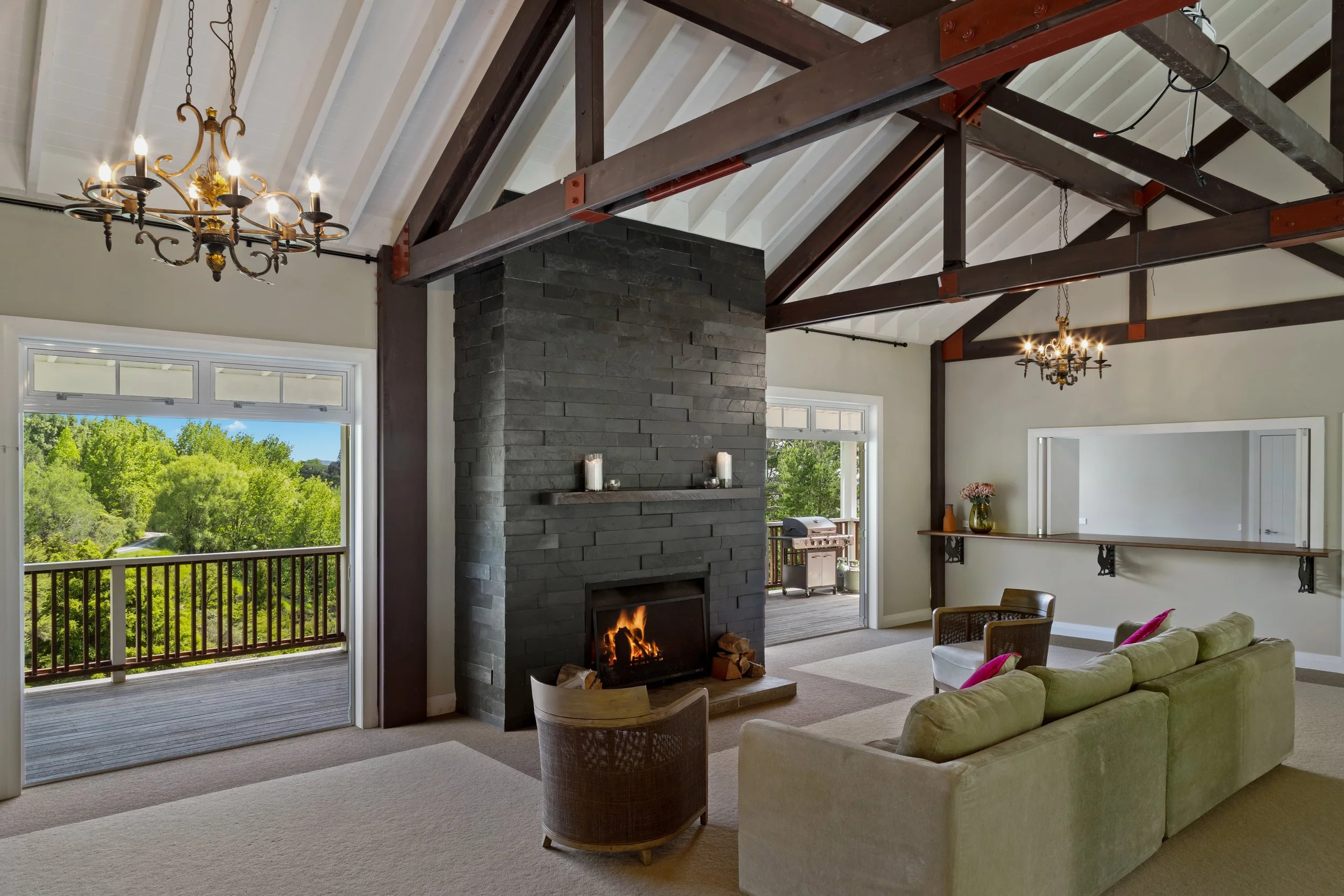 Lodge event space at Woodhouse Mountain Lodge in Matakana with fireplace, high ceilings and outdoor access.