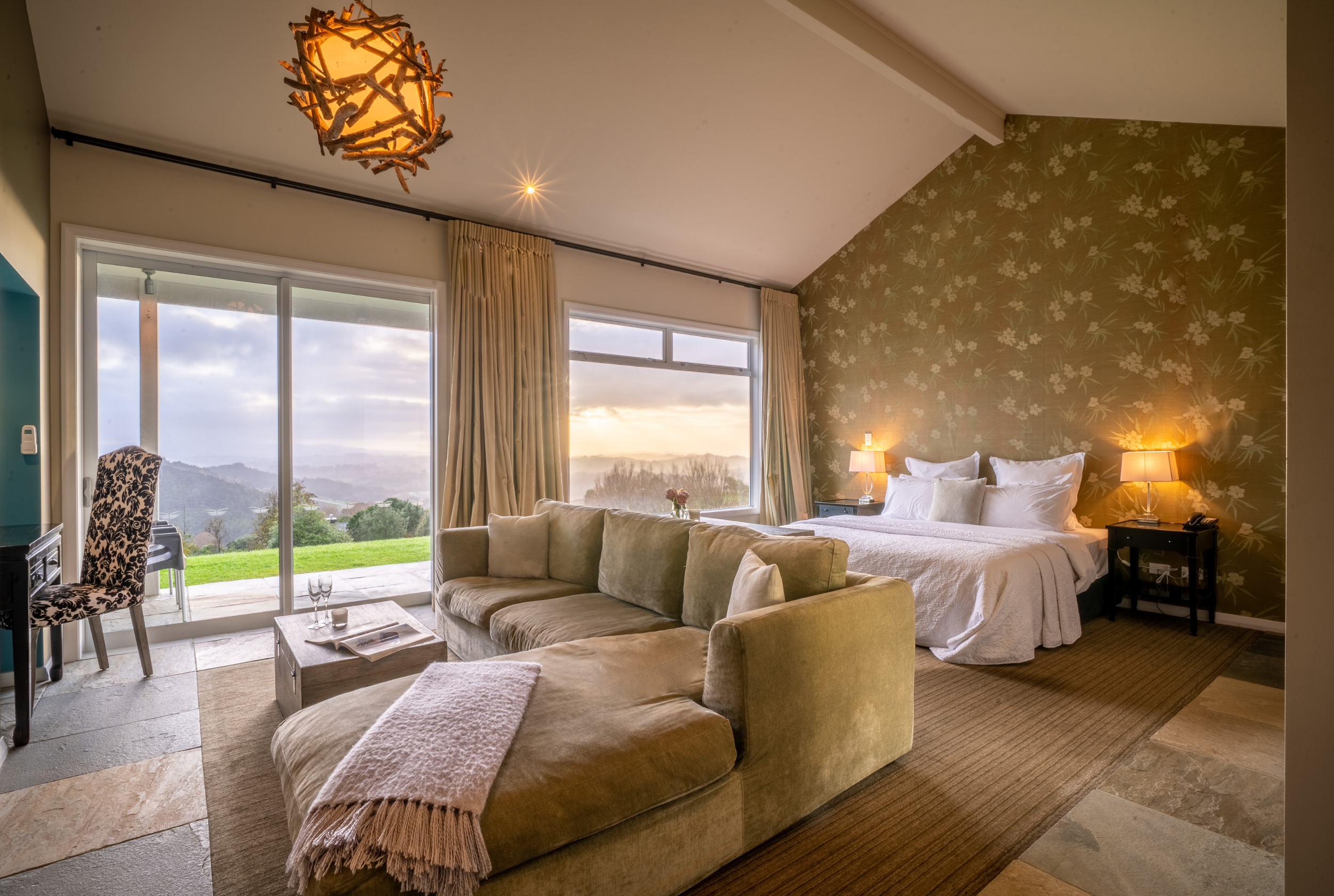 Villa accommodation at Woodhouse Mountain Lodge in Matakana with king bed, lounge area and panoramic countryside views.