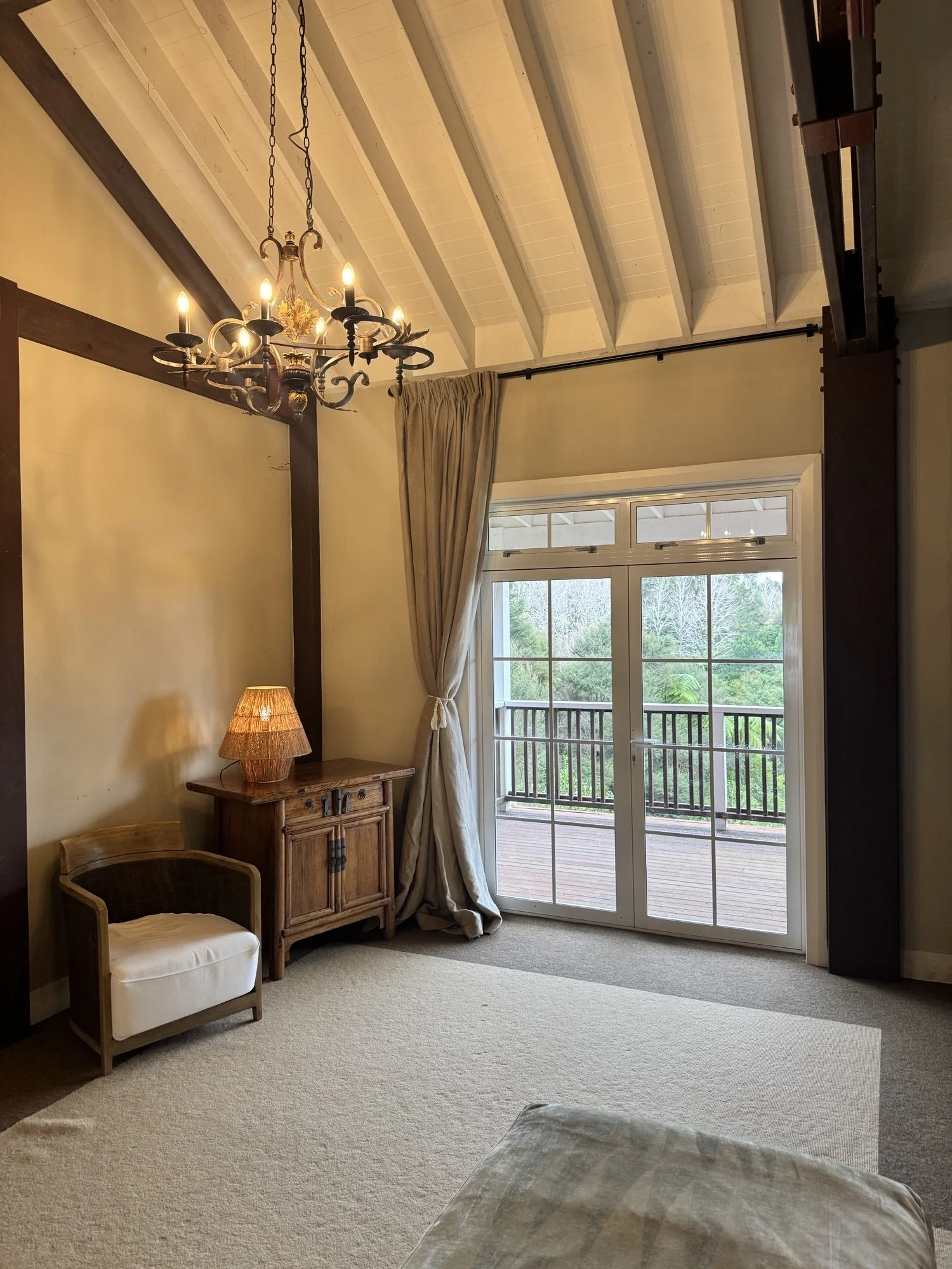 Intimate meeting and event space at Woodhouse Mountain Lodge in Matakana with high ceilings and access to a private outdoor deck.