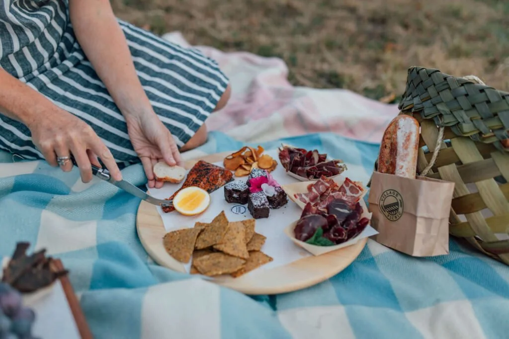 Vineyard picnic overlooking the Matakana coast and countryside near Woodhouse Mountain Lodge.