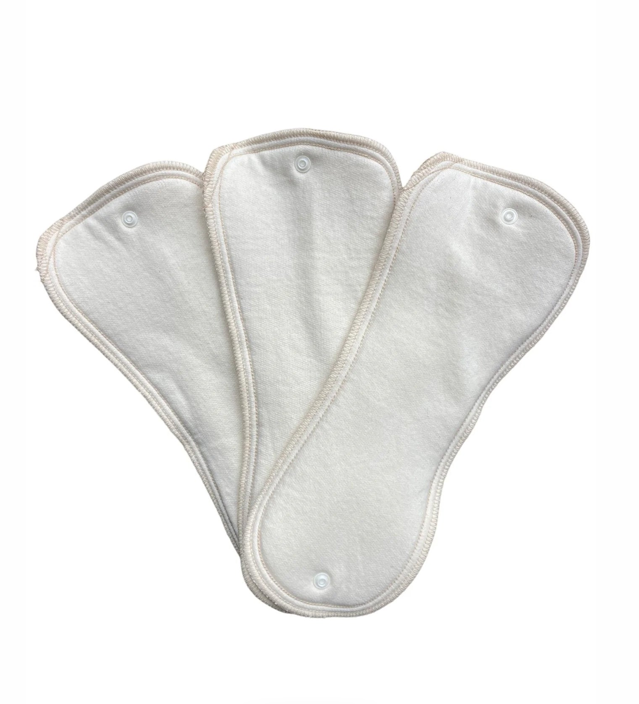 Three white reusable cloth menstrual pads with snap closures, arranged in a fan shape against a plain white background.