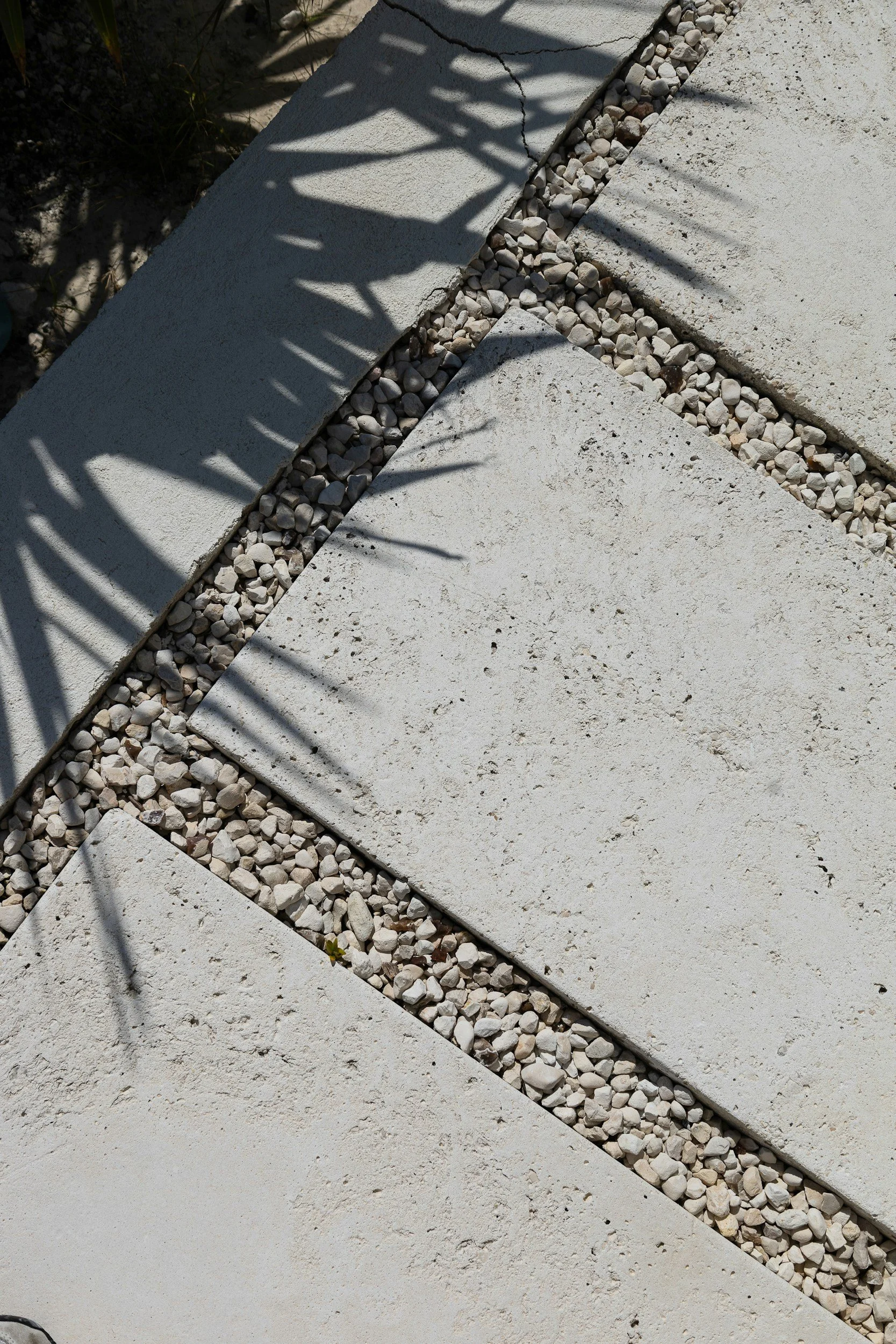 Concrete pathway with gravel stones.