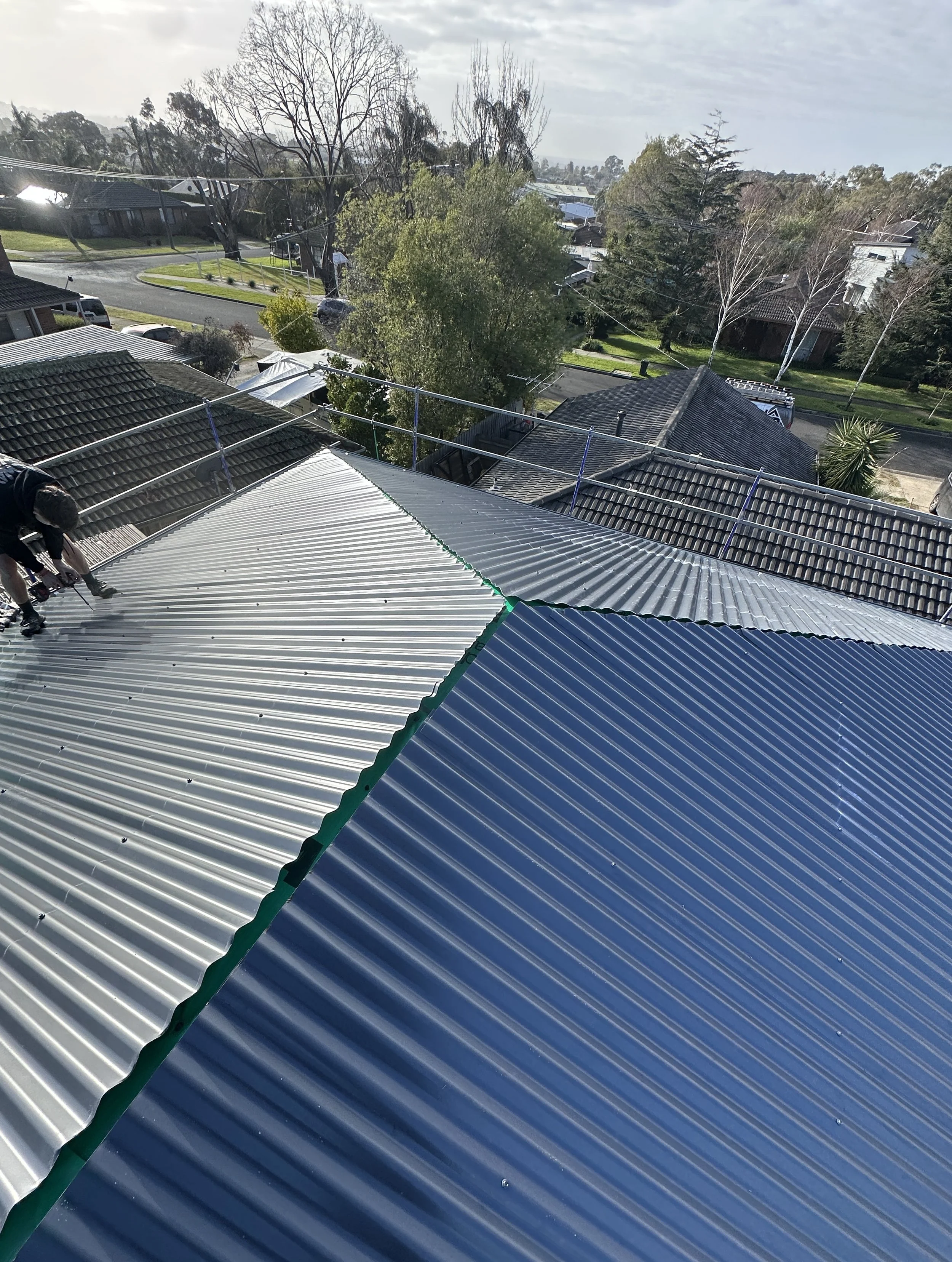 Licensed roofer completing a residential Colorbond roof replacement in Melbourne.