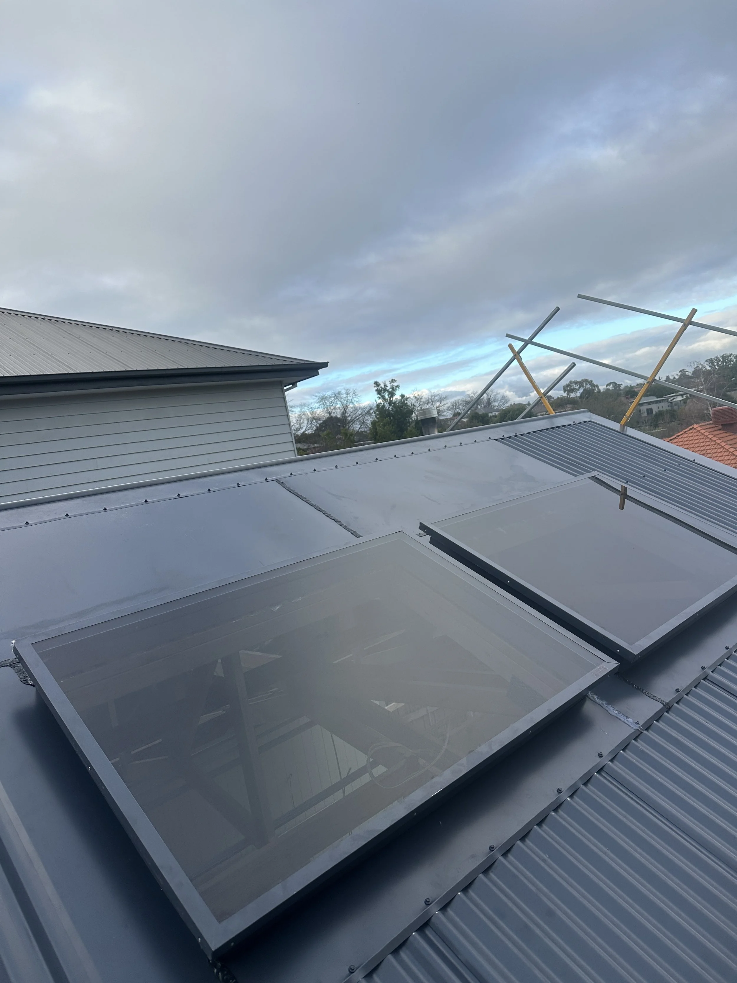 Colorbond roof installation with integrated solar panels completed by LPD Plumbing & Roofing.