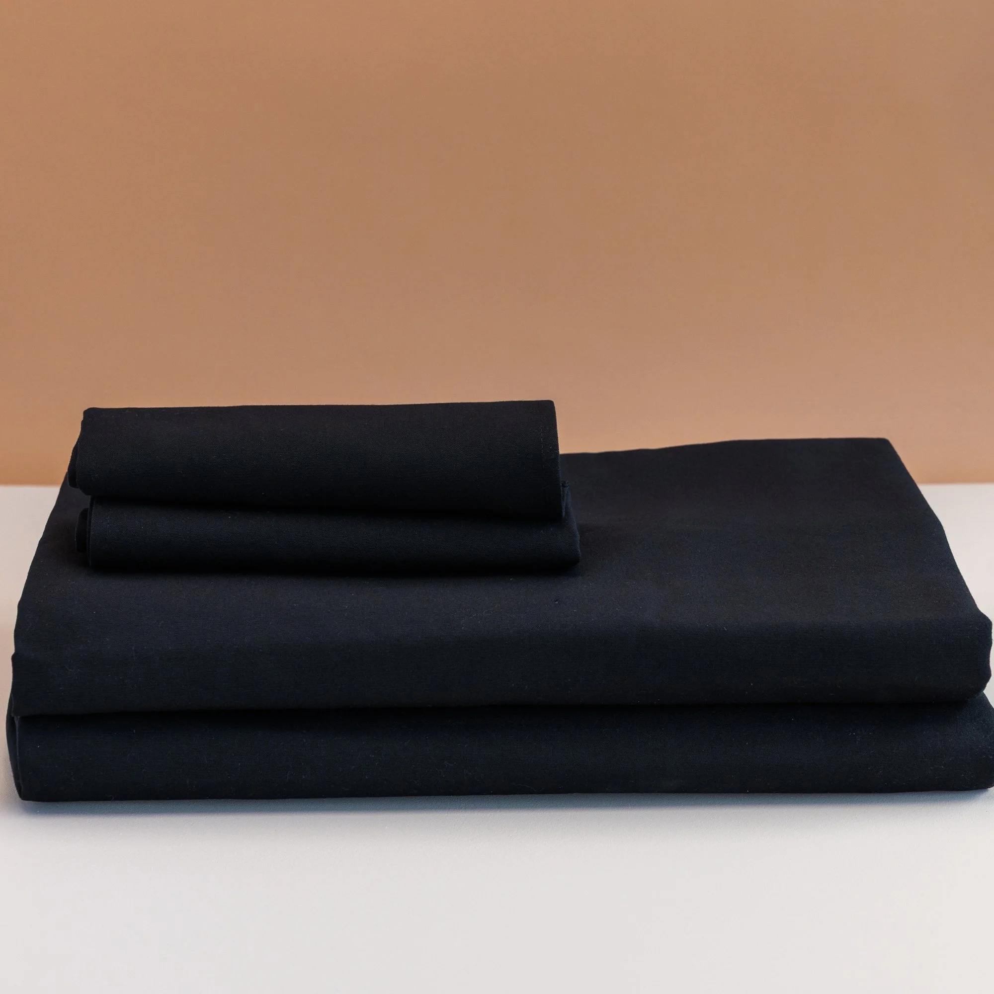 Black ring spun polyester tablecloth on event table — bulk table linen NZ
