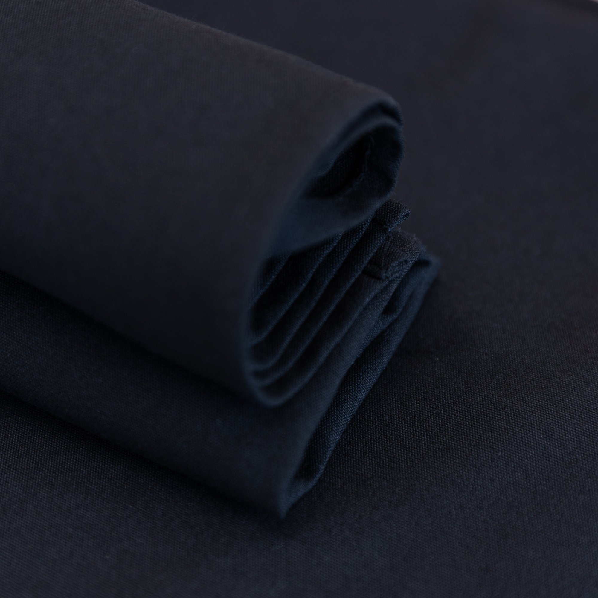 Close-up of ring spun polyester tablecloth drape — stain resistant event linen NZ