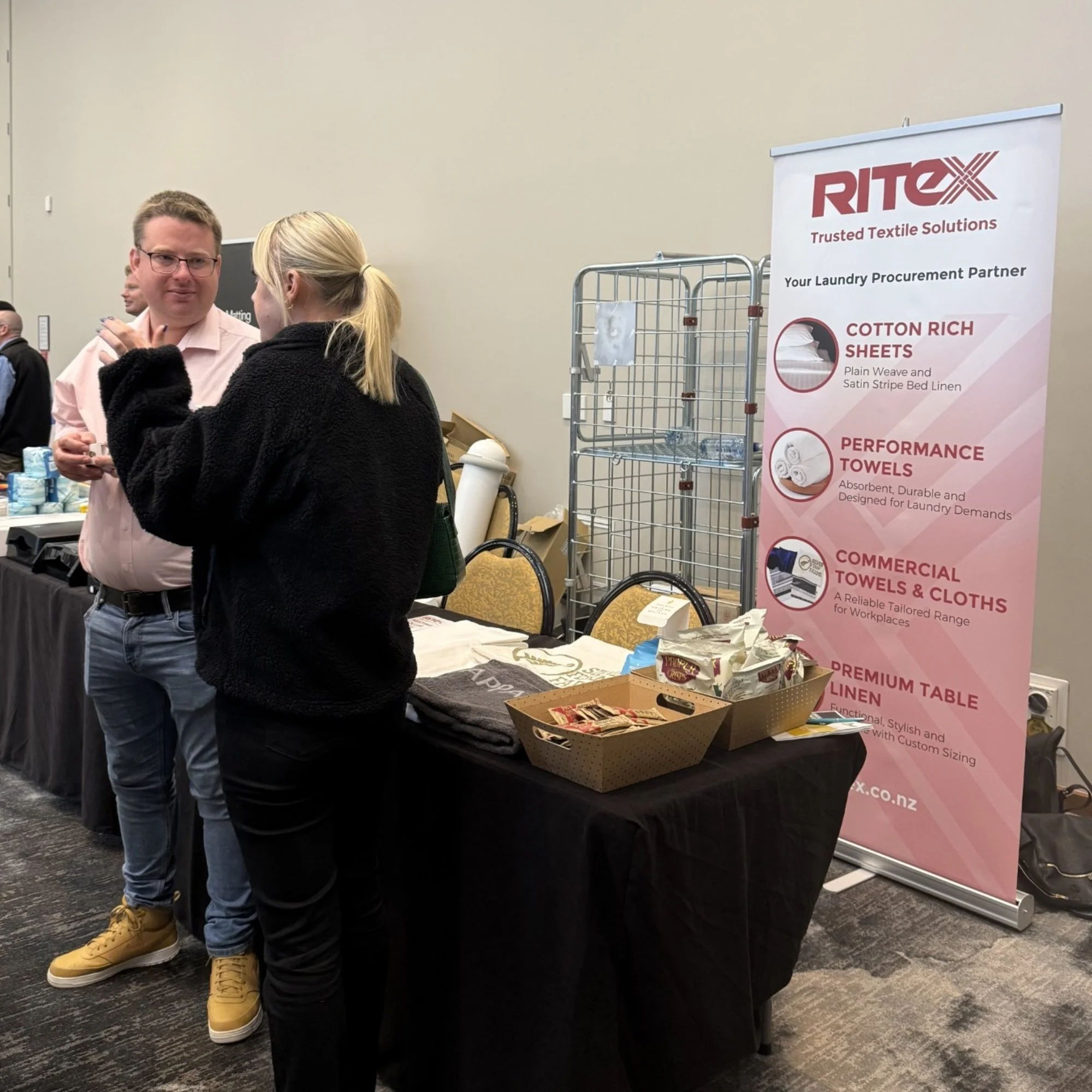 Ritex team discussing commercial textile solutions at an industry trade event