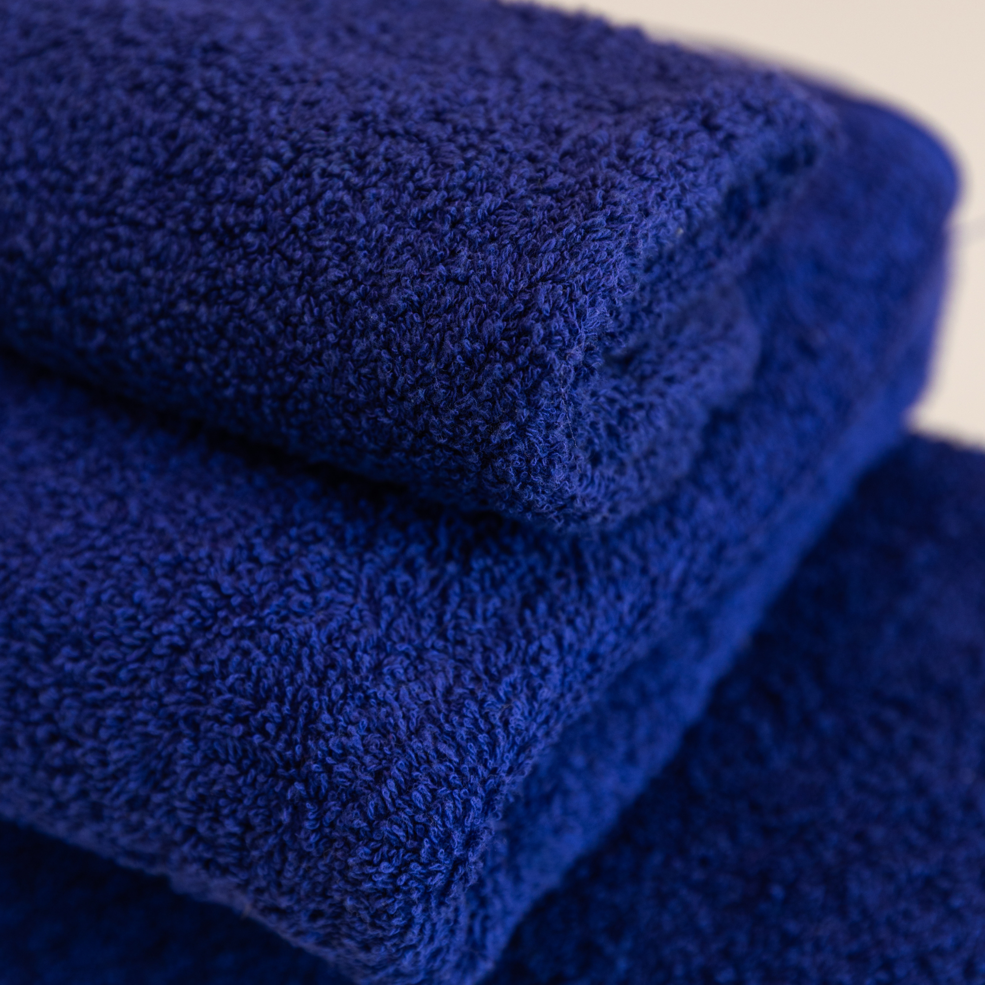 Close-up of stacked blue textured Kahurangi towels.