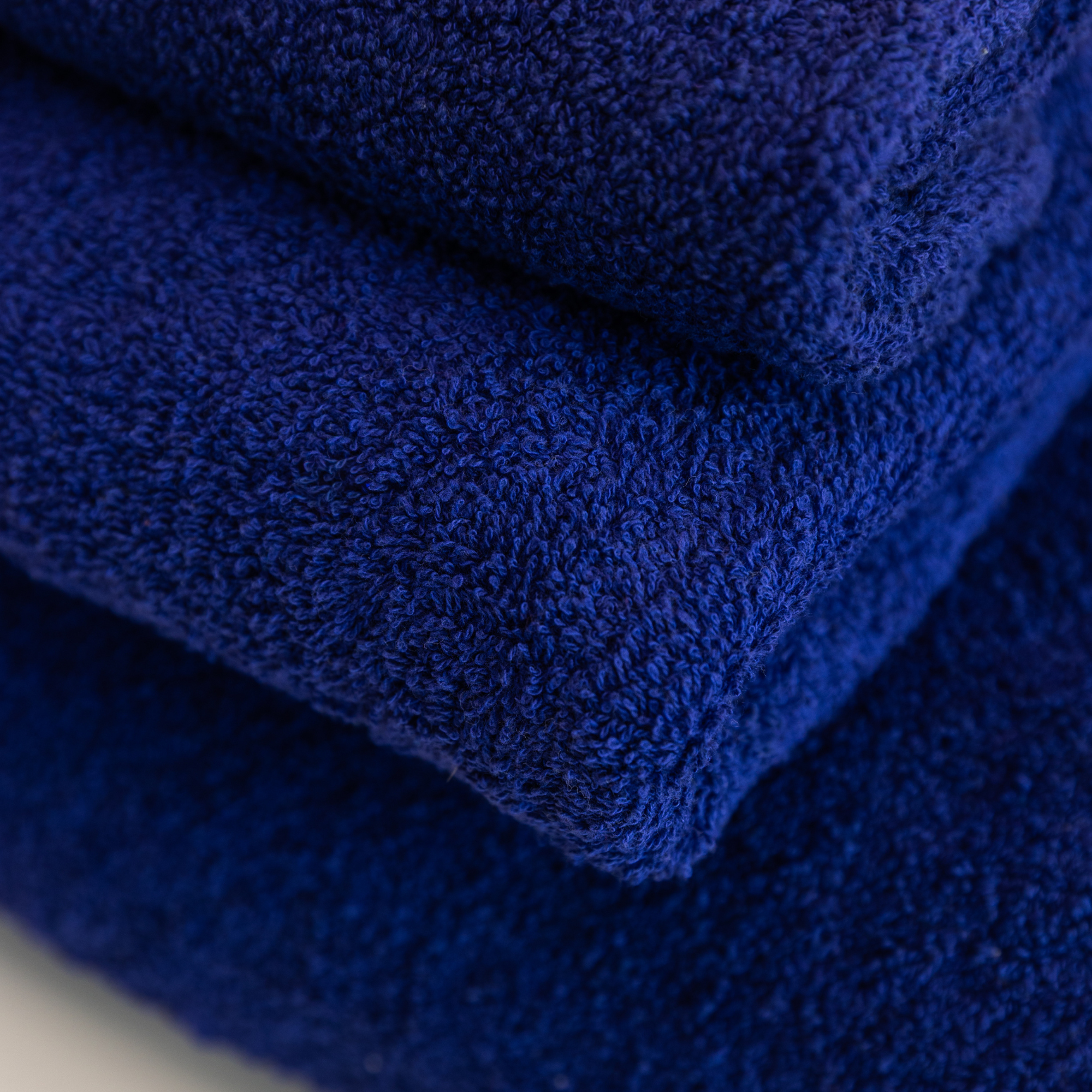 Close-up of stacked, textured blue Kahurangi towels.