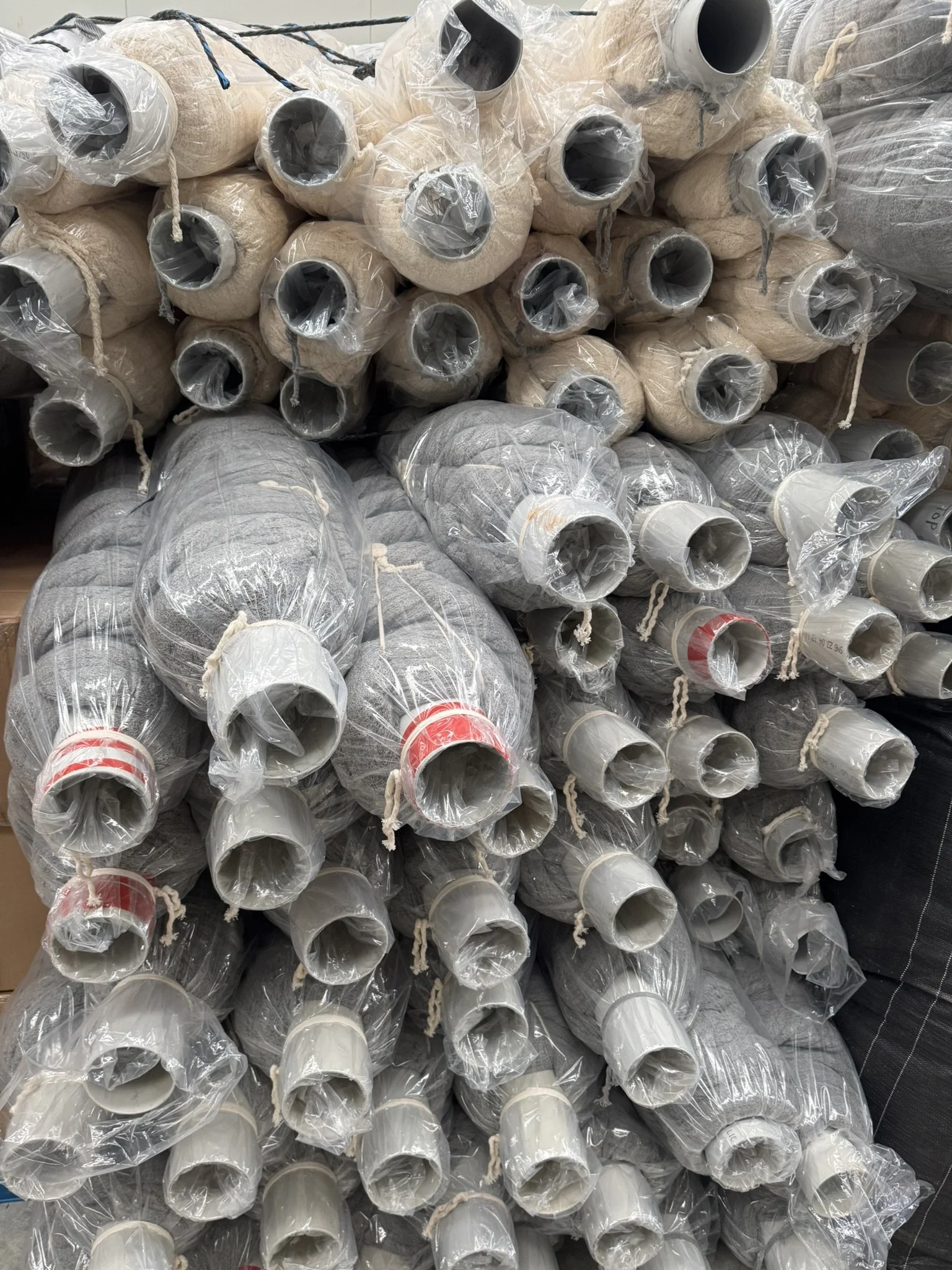 Mussel socking rolls wrapped in single-use plastic — the problem the Mussock DryBag was designed to solve