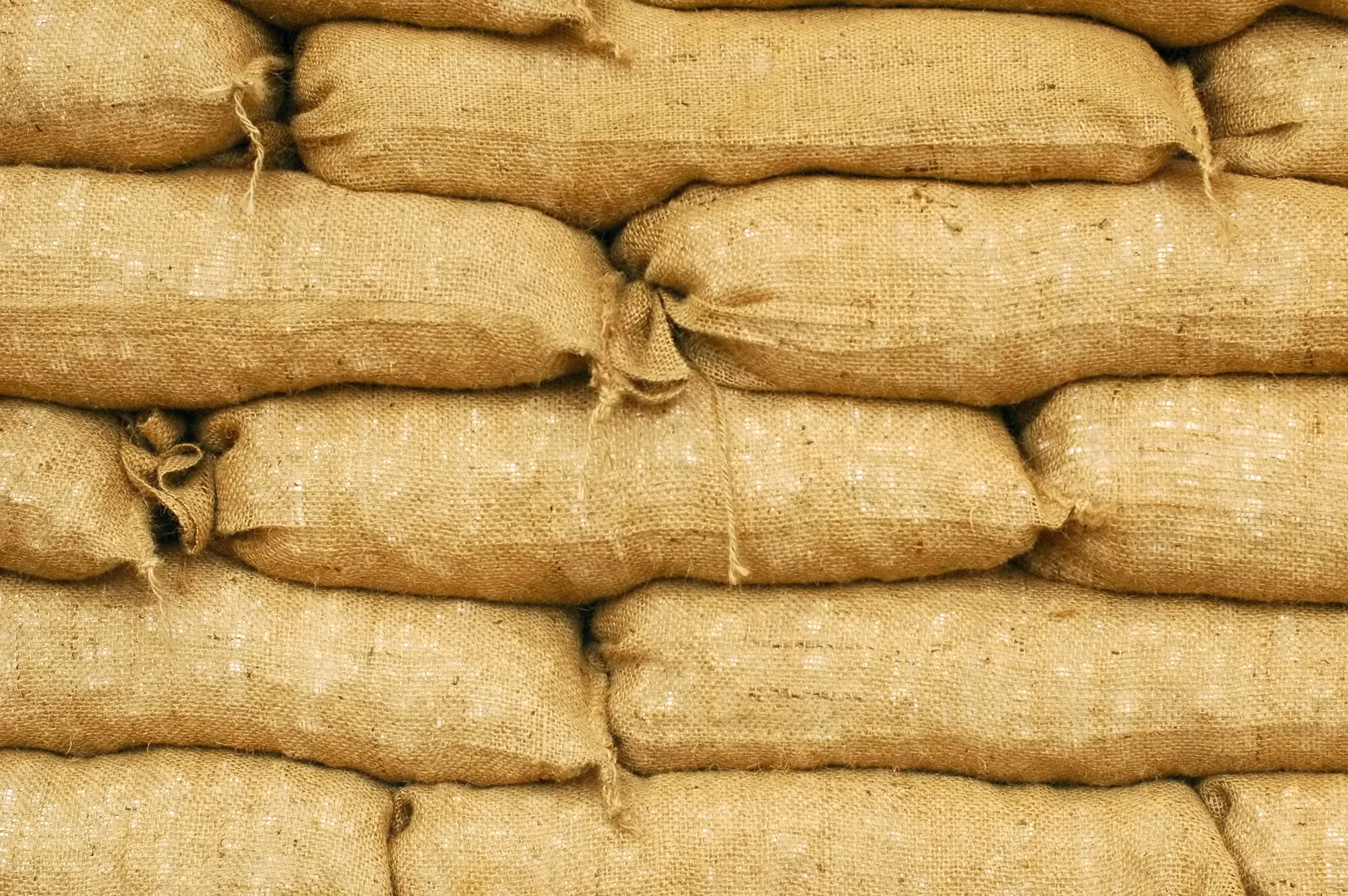 Stack of jute sacks tied with twine.