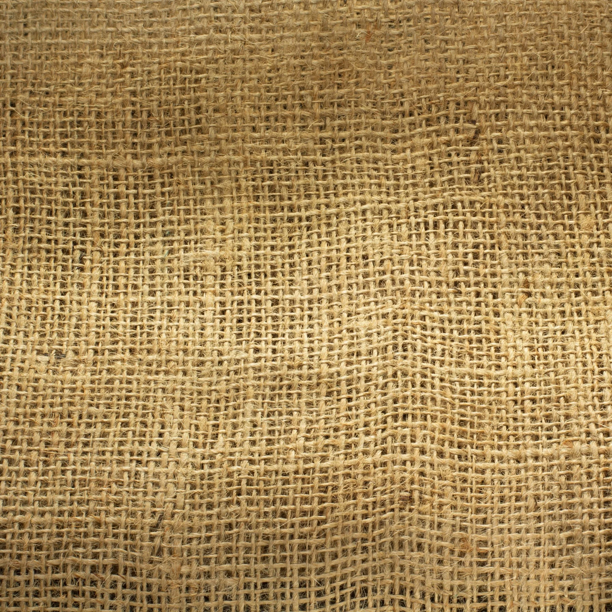 Close-up of a woven burlap fabric with a rough texture.