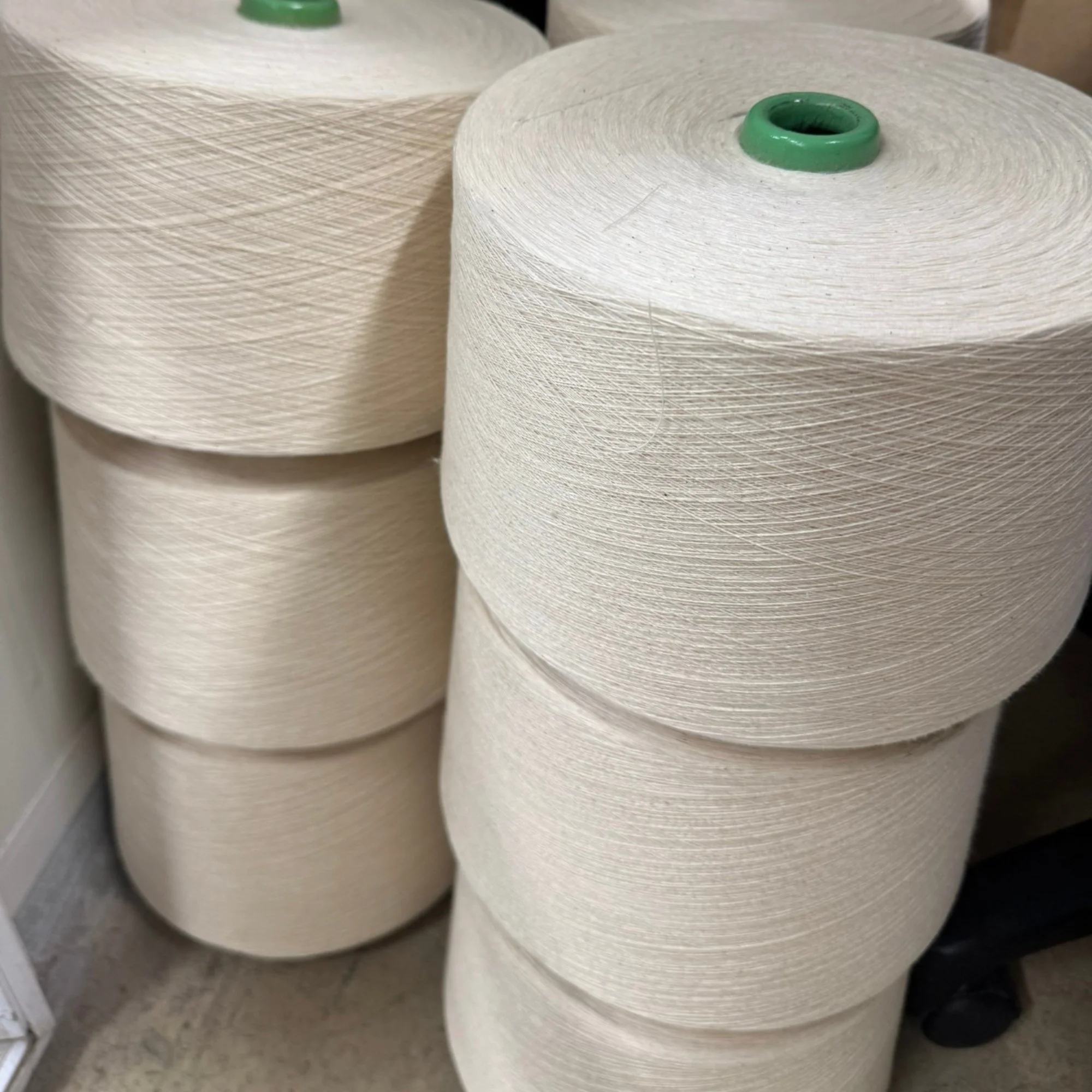Large spools of white Mussock Saffron Yarn