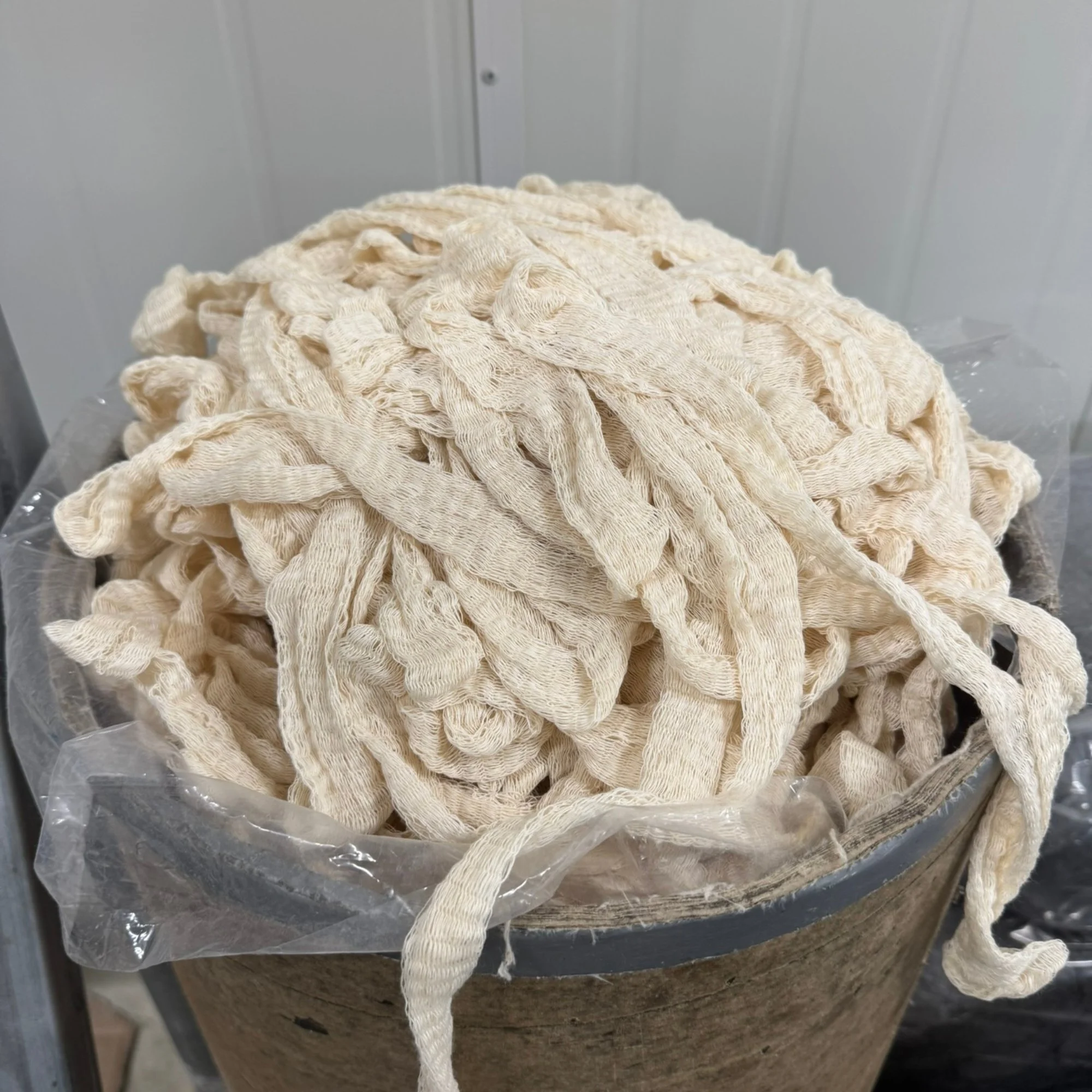 A large pile of white knitted mussock socking using Mussock Saffron Yarn.