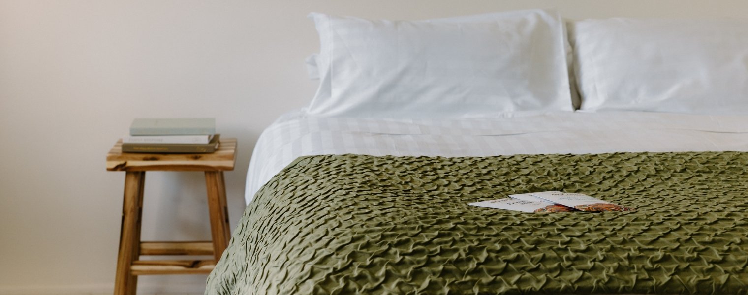Rutherford 25mm striped sheets on a bed