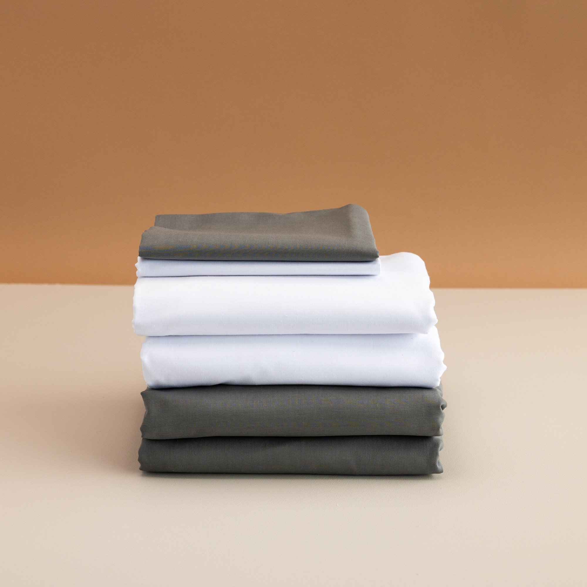 Stacked neatly, folded white, gray Aged Care and RSE Knitted Sheet Set.jpg